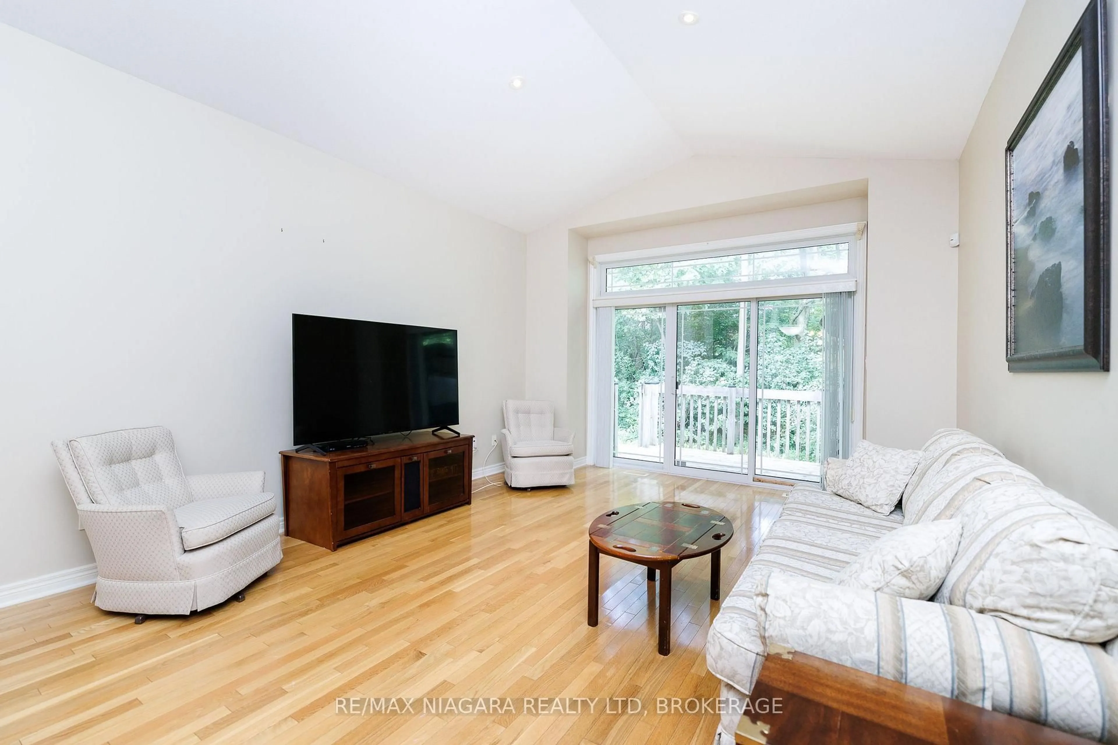 Living room with furniture, wood/laminate floor for 3300 Montrose Rd #8, Niagara Falls Ontario L2H 3L9