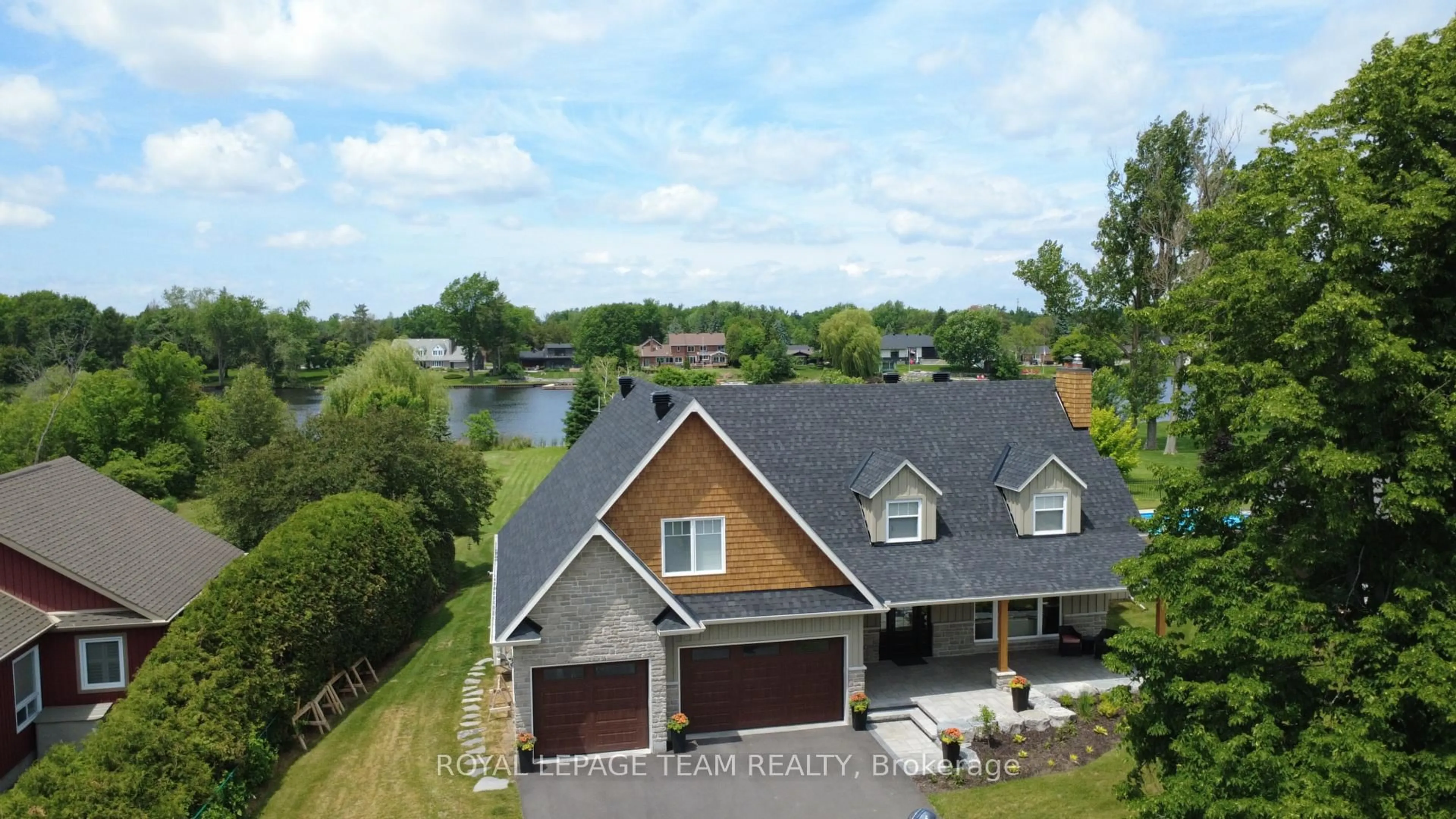 A pic from outside/outdoor area/front of a property/back of a property/a pic from drone, water/lake/river/ocean view for 2710 River Rd, Manotick Ontario K4M 1A3