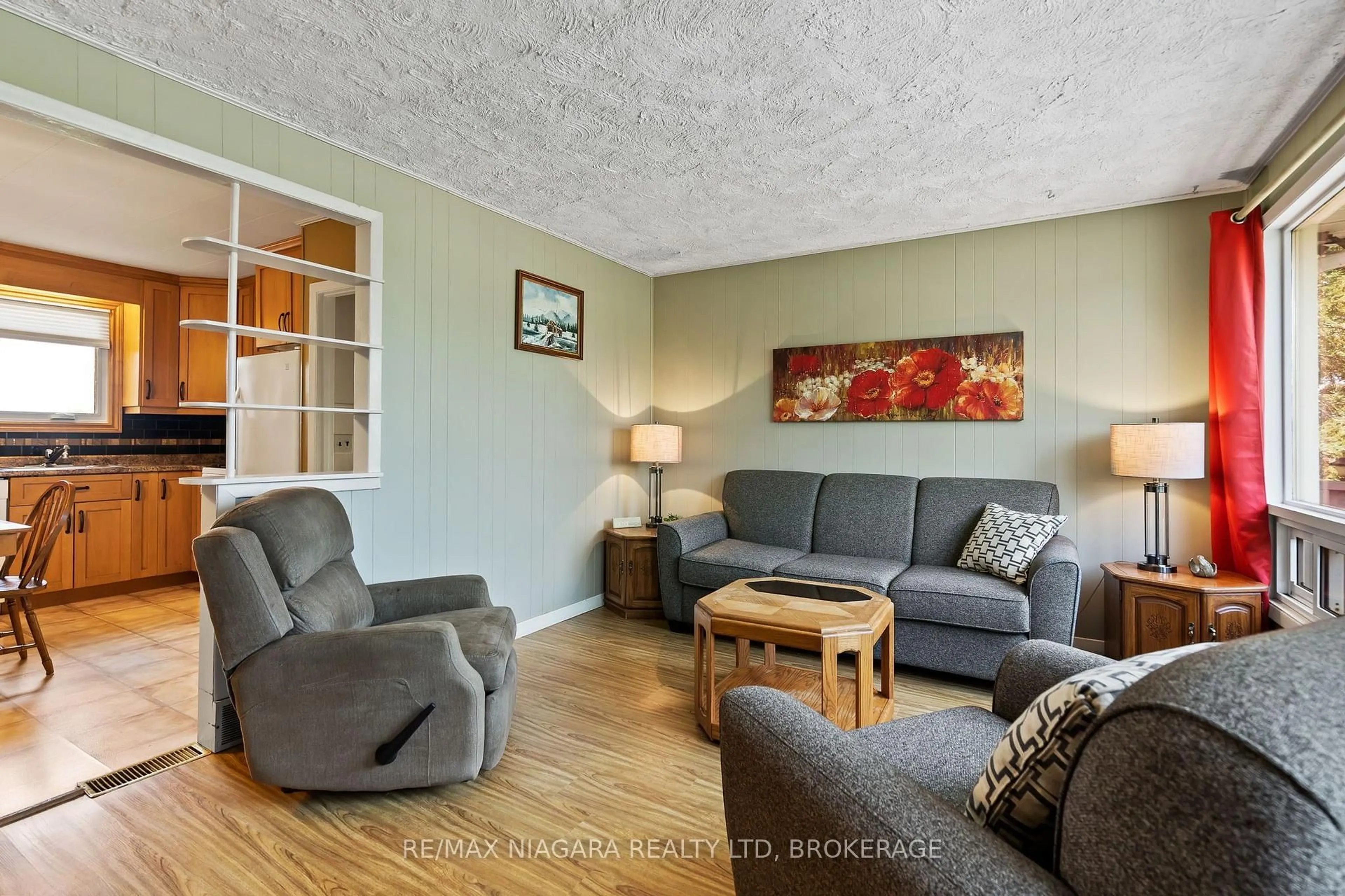 Living room with furniture, wood/laminate floor for 42058 Hwy 3, Wainfleet Ontario L0S 1V0