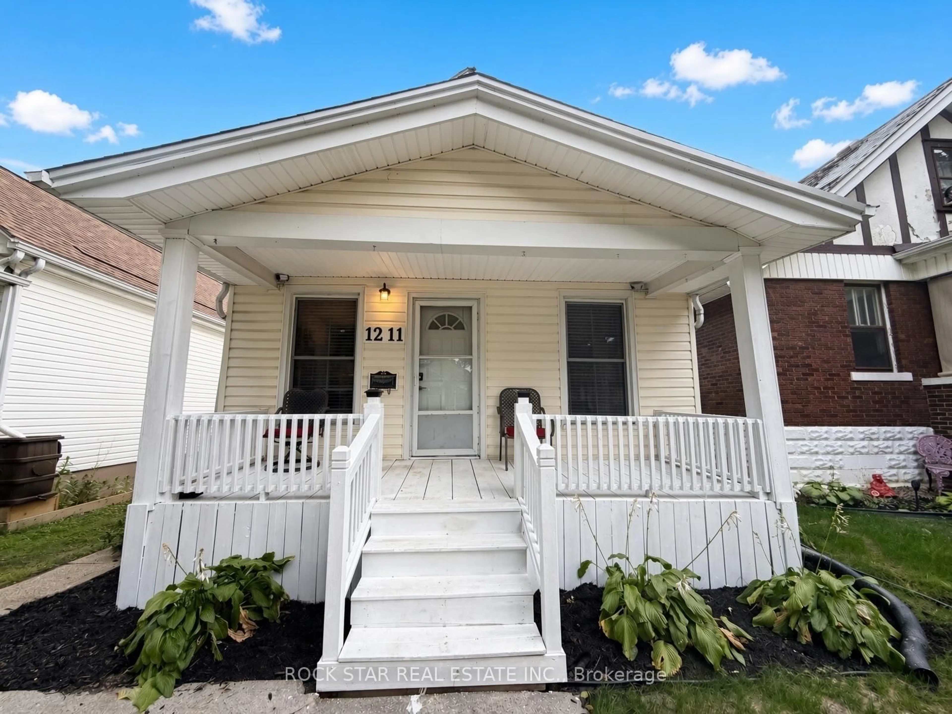 Home with vinyl exterior material, street for 1211 Lincoln Rd, Windsor Ontario N8Y 2H9