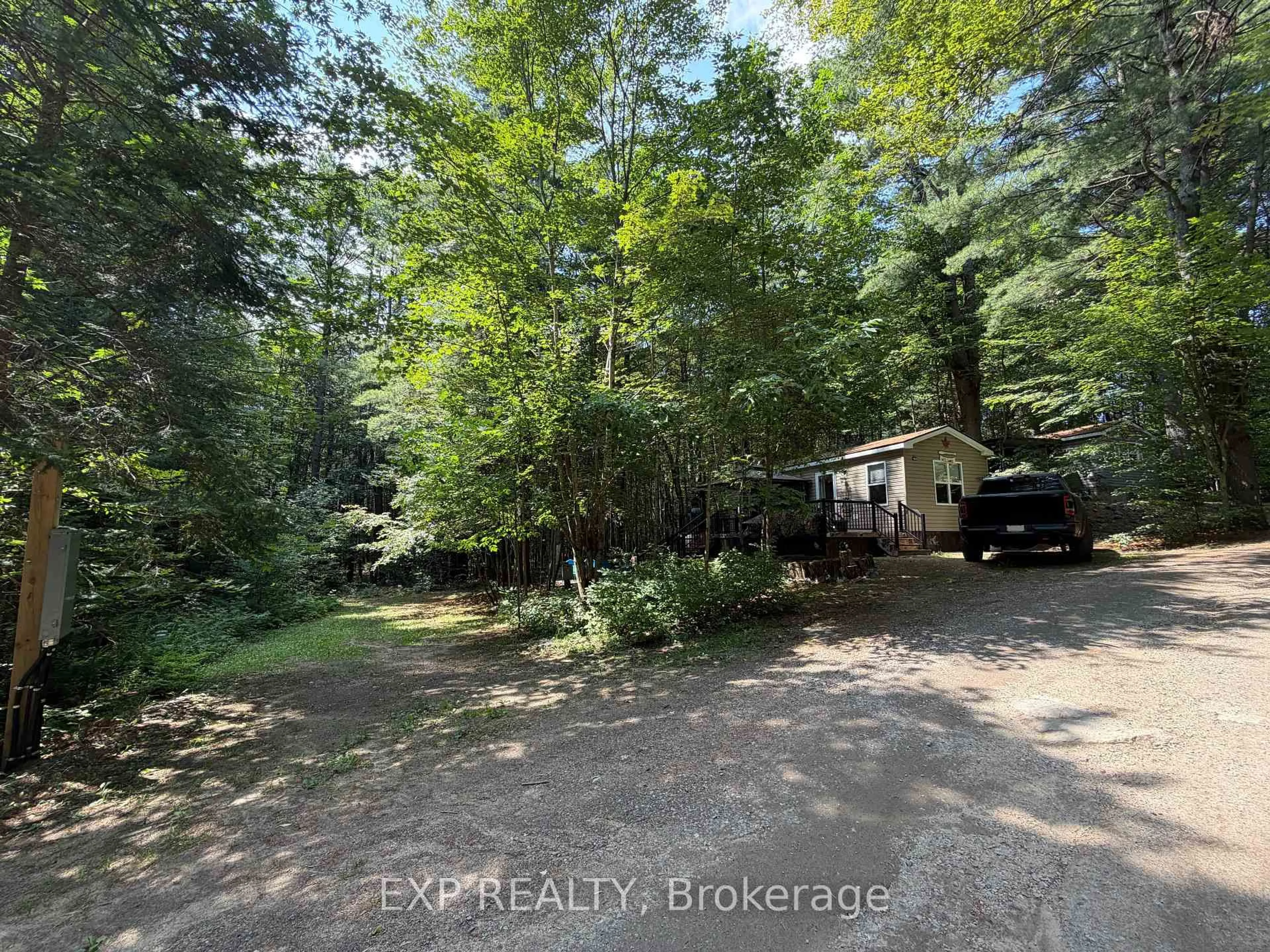 A pic from outside/outdoor area/front of a property/back of a property/a pic from drone, forest/trees view for 1047 Bonnie Lake Camp Rd #740 Poplar Cres, Bracebridge Ontario P1L 1W9
