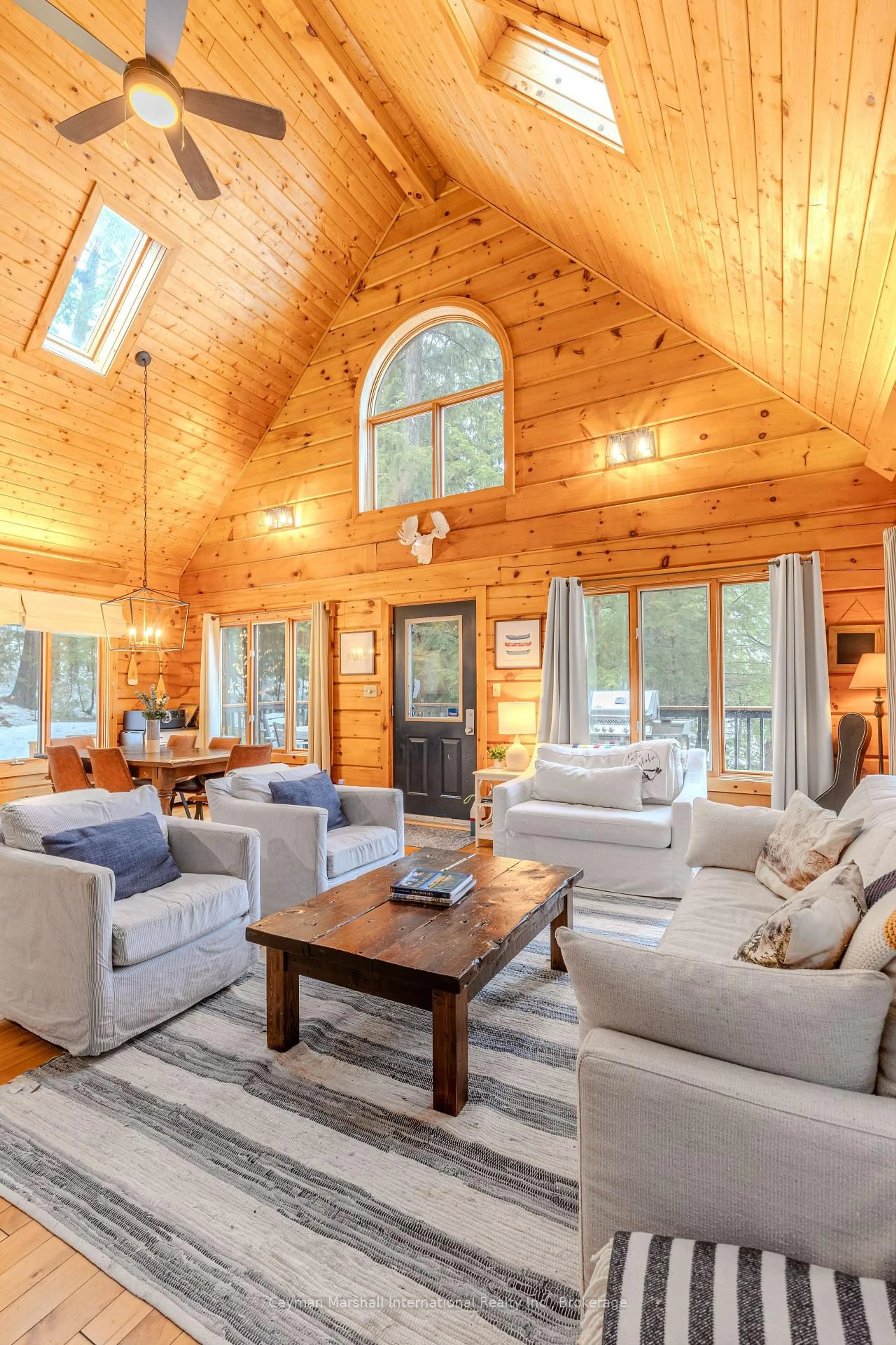 Living room with furniture, wood/laminate floor for 1186 Ashforth Dr, Muskoka Lakes Ontario P0C 1M0