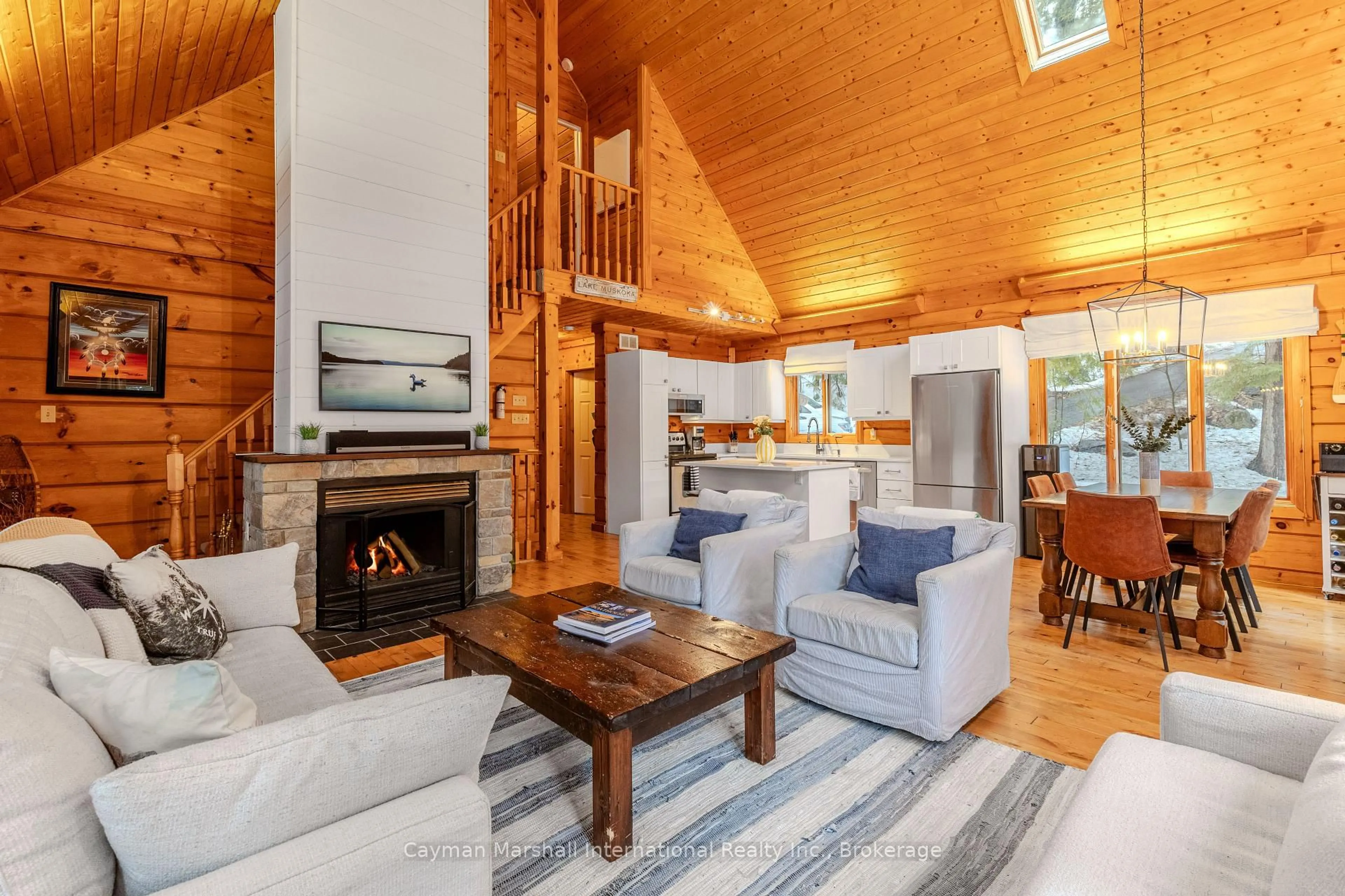 Living room with furniture, wood/laminate floor for 1186 Ashforth Dr, Muskoka Lakes Ontario P0C 1M0
