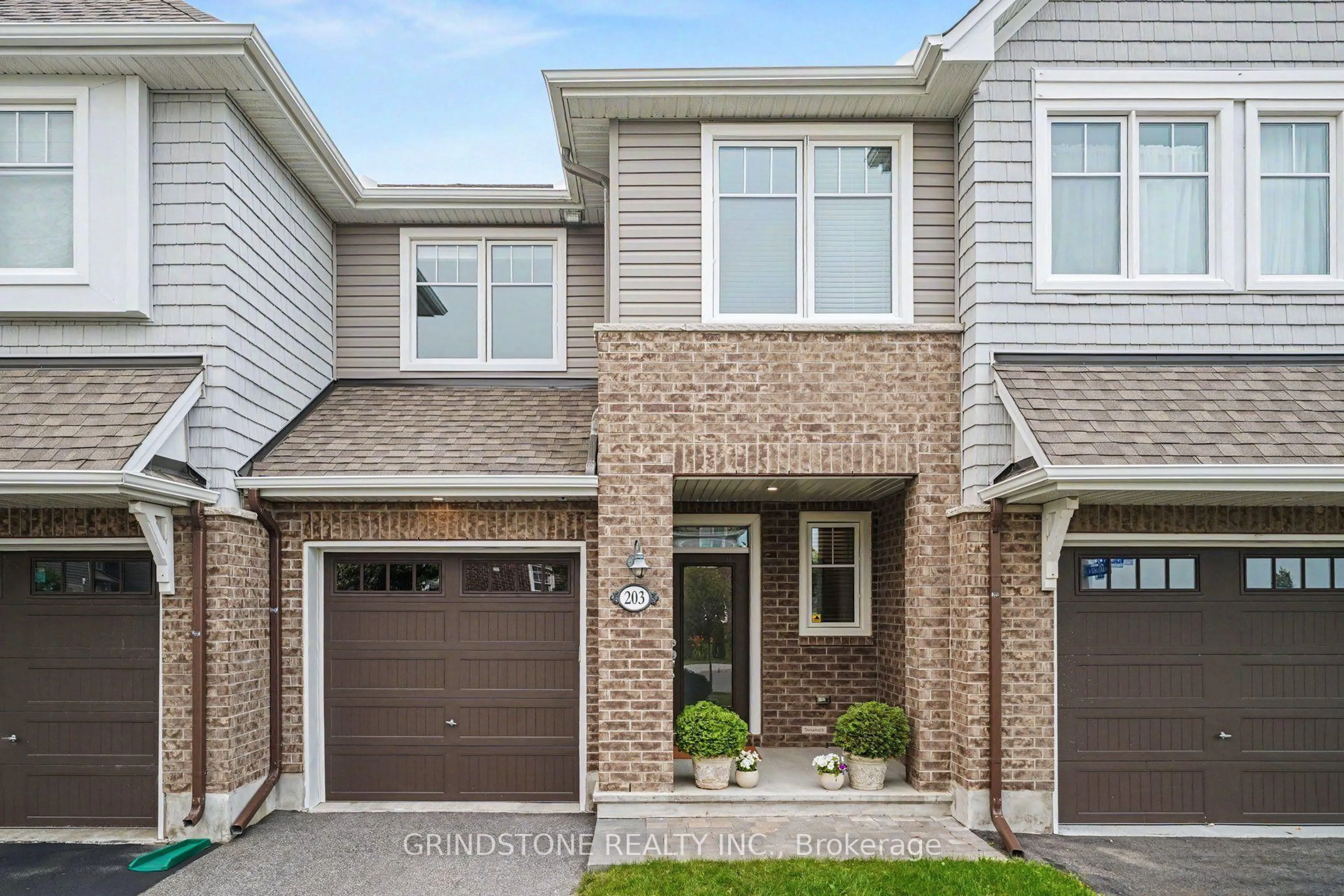Home with brick exterior material, street for 203 Trollius Way, Ottawa Ontario K1T 0R7
