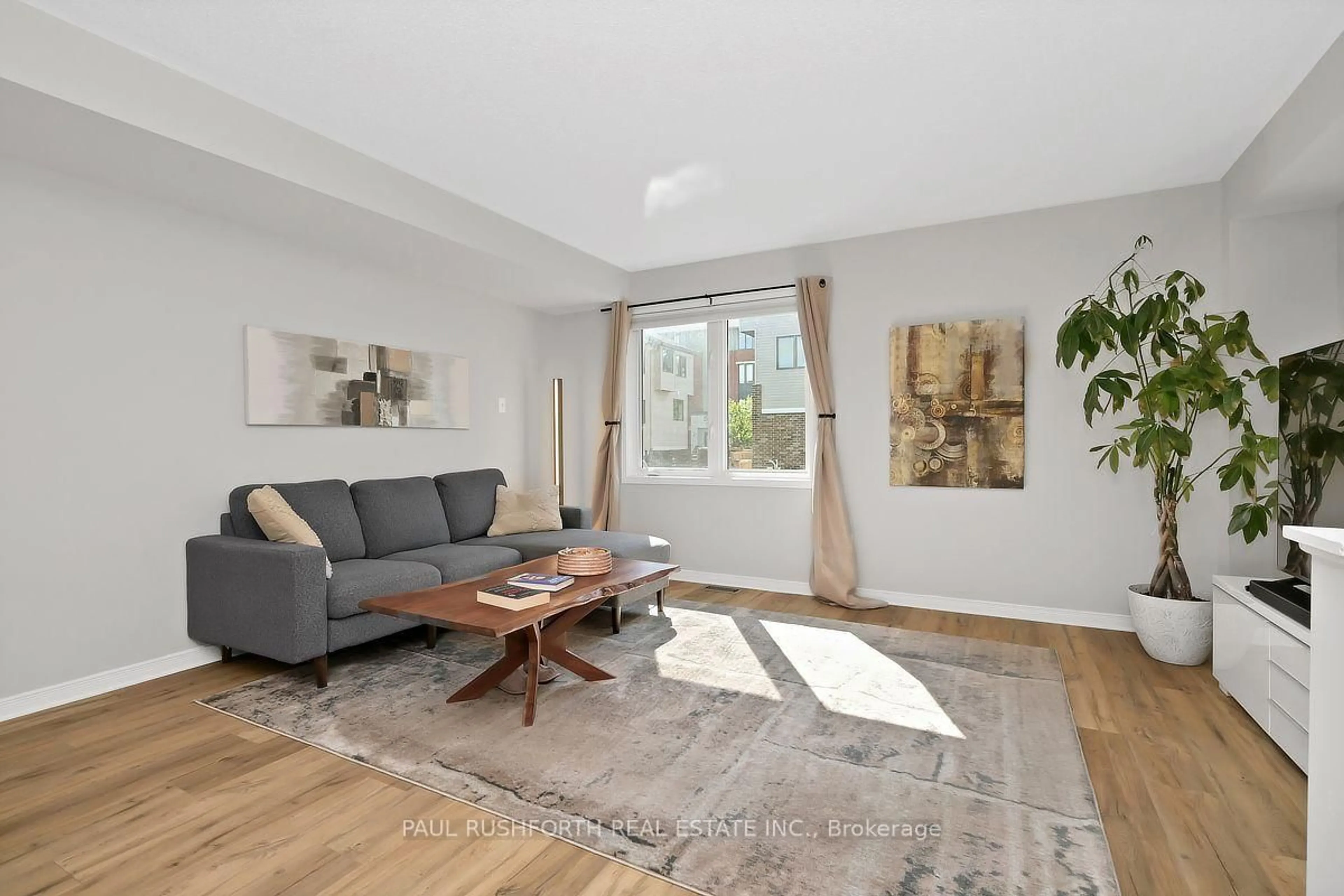 Living room with furniture, wood/laminate floor for 243 Eric Czapnik Way, Ottawa Ontario K1E 0B4