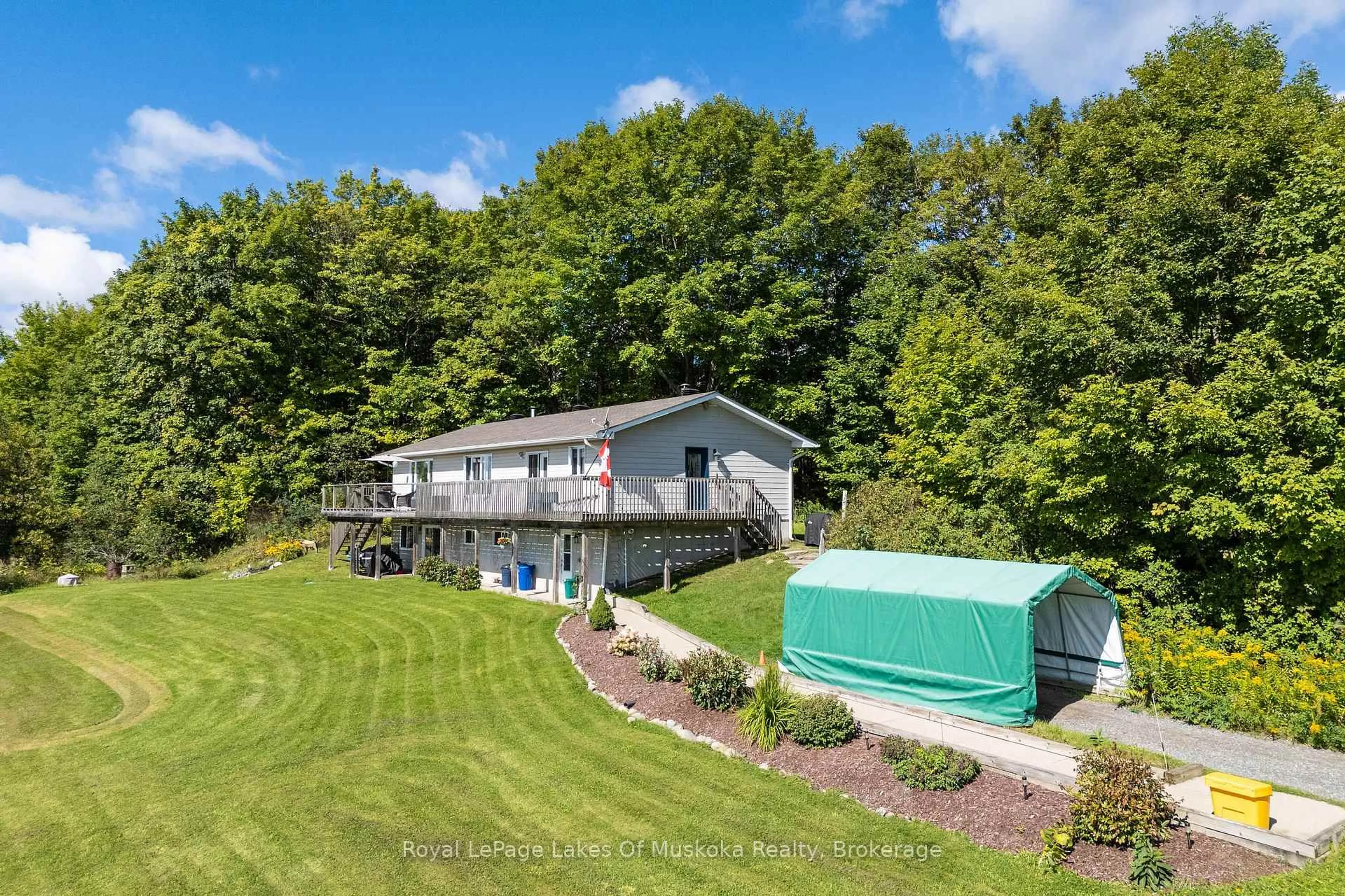 A pic from outside/outdoor area/front of a property/back of a property/a pic from drone, water/lake/river/ocean view for 382 60 Highway, Huntsville Ontario P1H 1B6