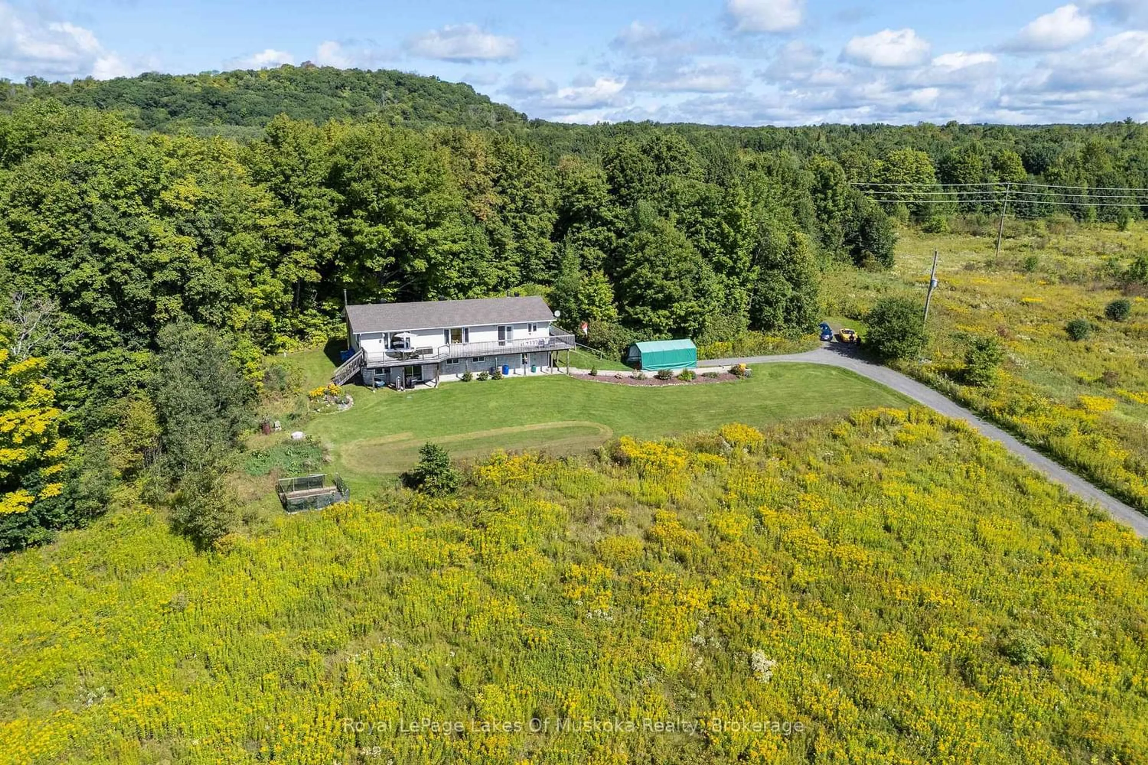 A pic from outside/outdoor area/front of a property/back of a property/a pic from drone, water/lake/river/ocean view for 382 60 Highway, Huntsville Ontario P1H 1B6