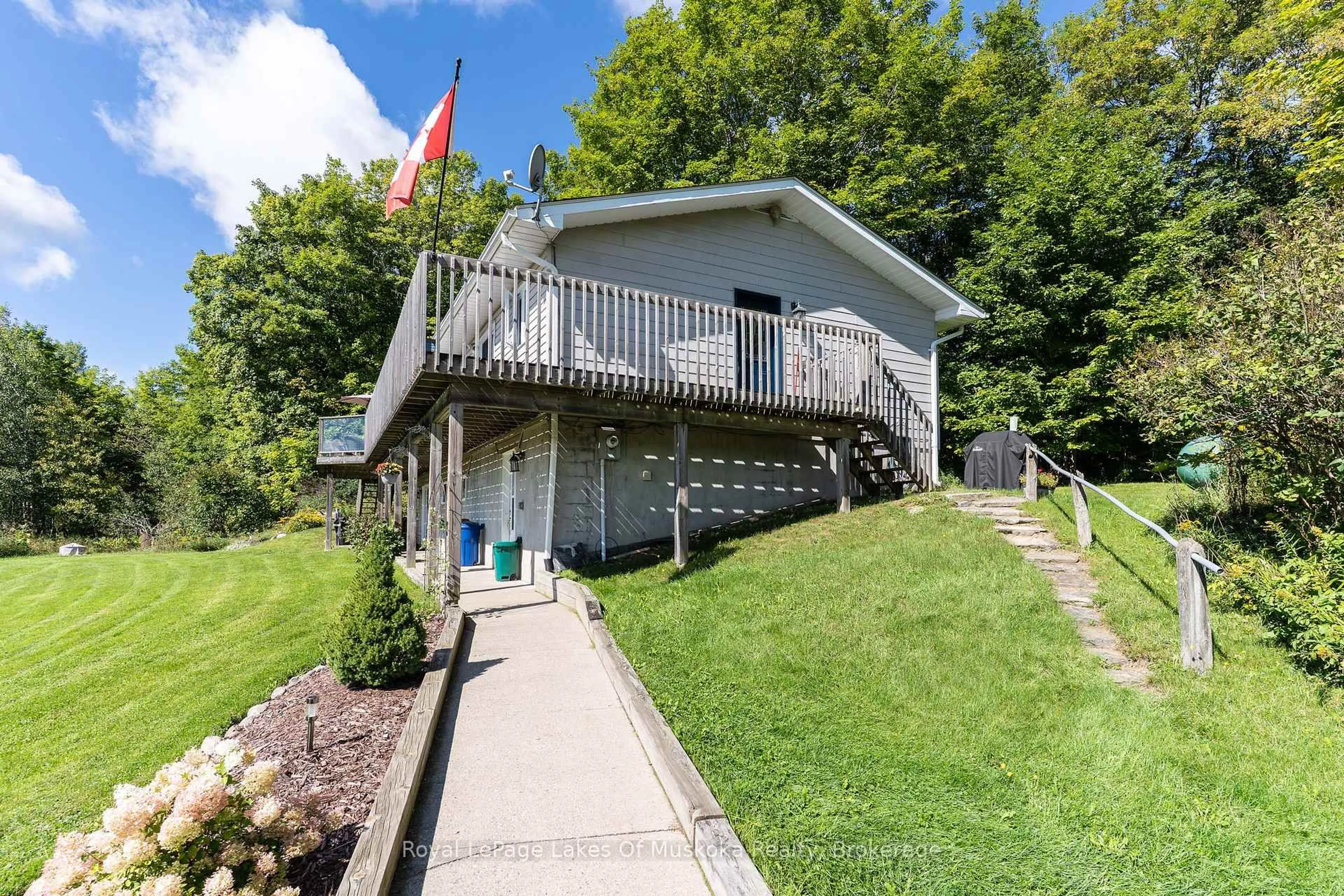 A pic from outside/outdoor area/front of a property/back of a property/a pic from drone, water/lake/river/ocean view for 382 60 Highway, Huntsville Ontario P1H 1B6