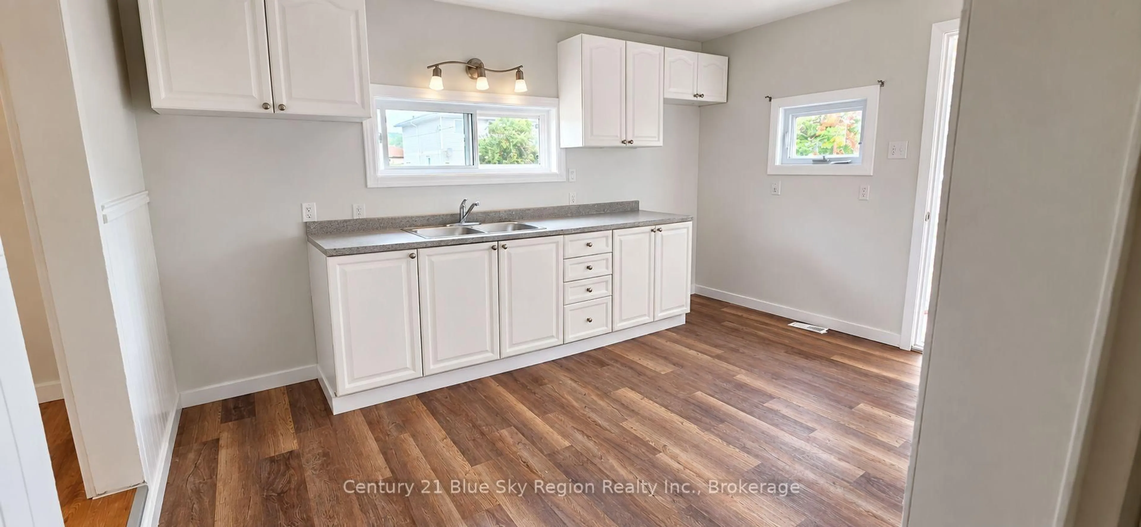 Open concept kitchen, wood/laminate floor for 239 Gould Ave, North Bay Ontario P1B 7C6