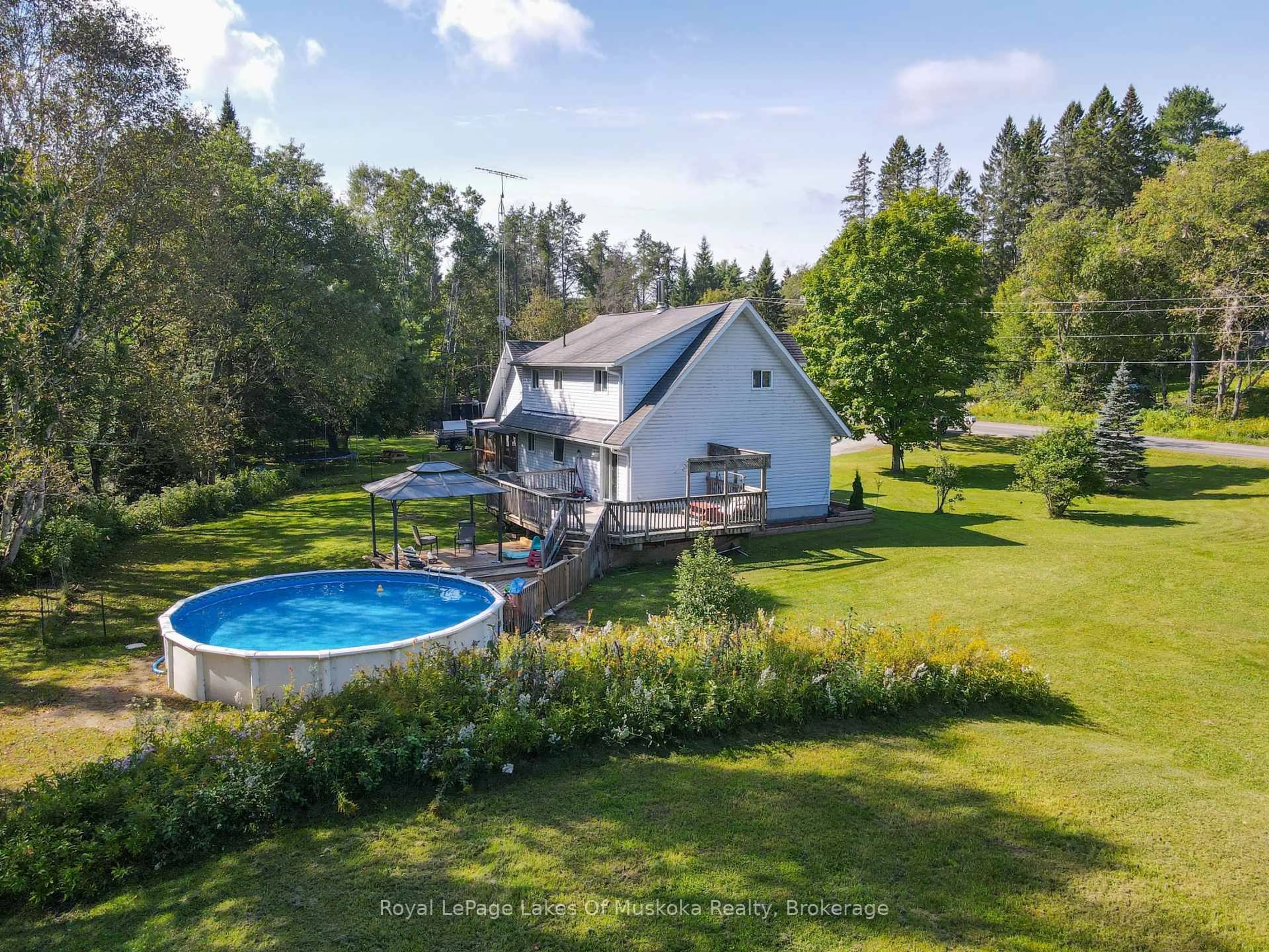 A pic from outside/outdoor area/front of a property/back of a property/a pic from drone, water/lake/river/ocean view for 911 Deer Lake Rd, Huntsville Ontario P0B 1L0