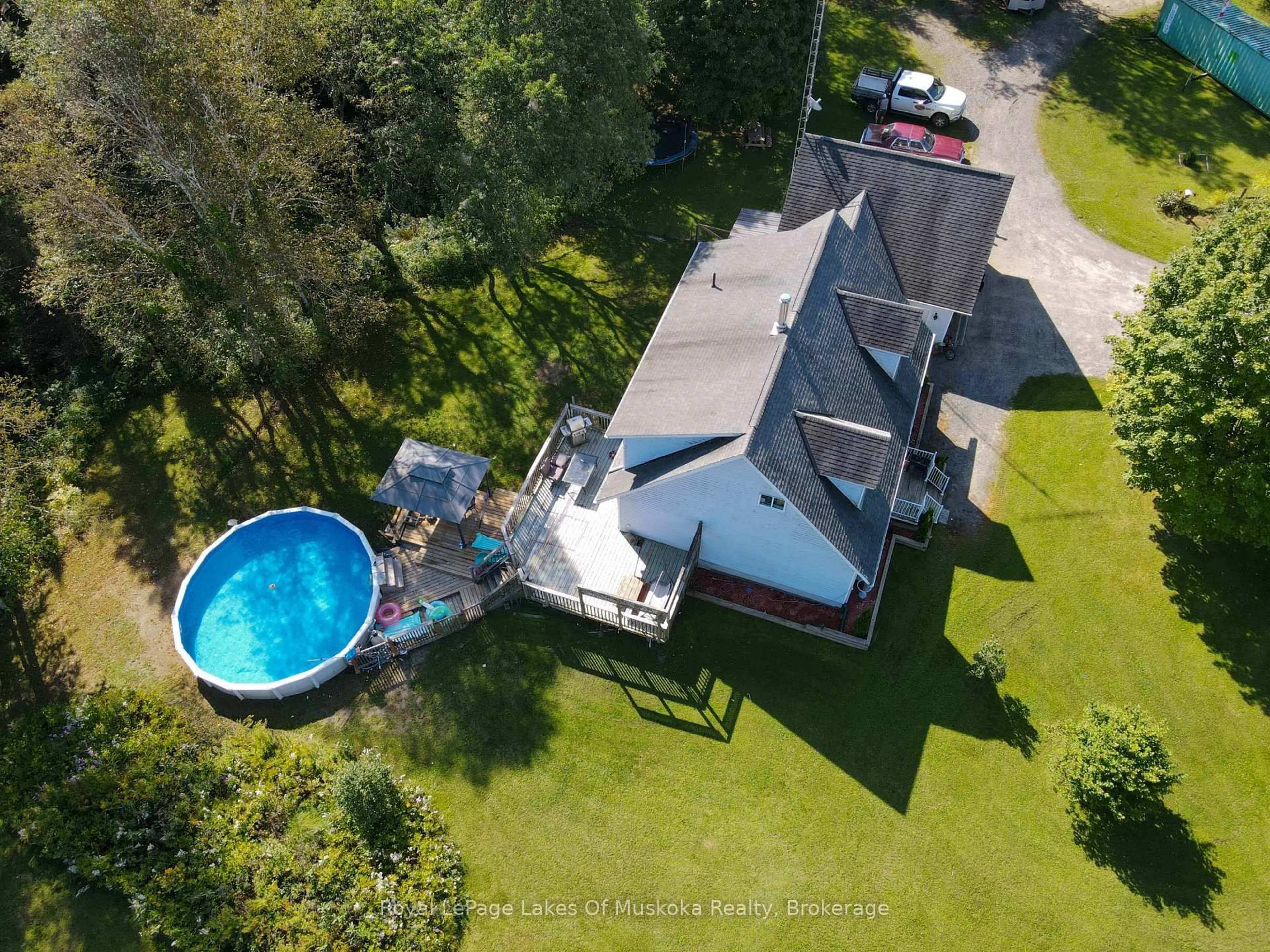 A pic from outside/outdoor area/front of a property/back of a property/a pic from drone, water/lake/river/ocean view for 911 Deer Lake Rd, Huntsville Ontario P0B 1L0