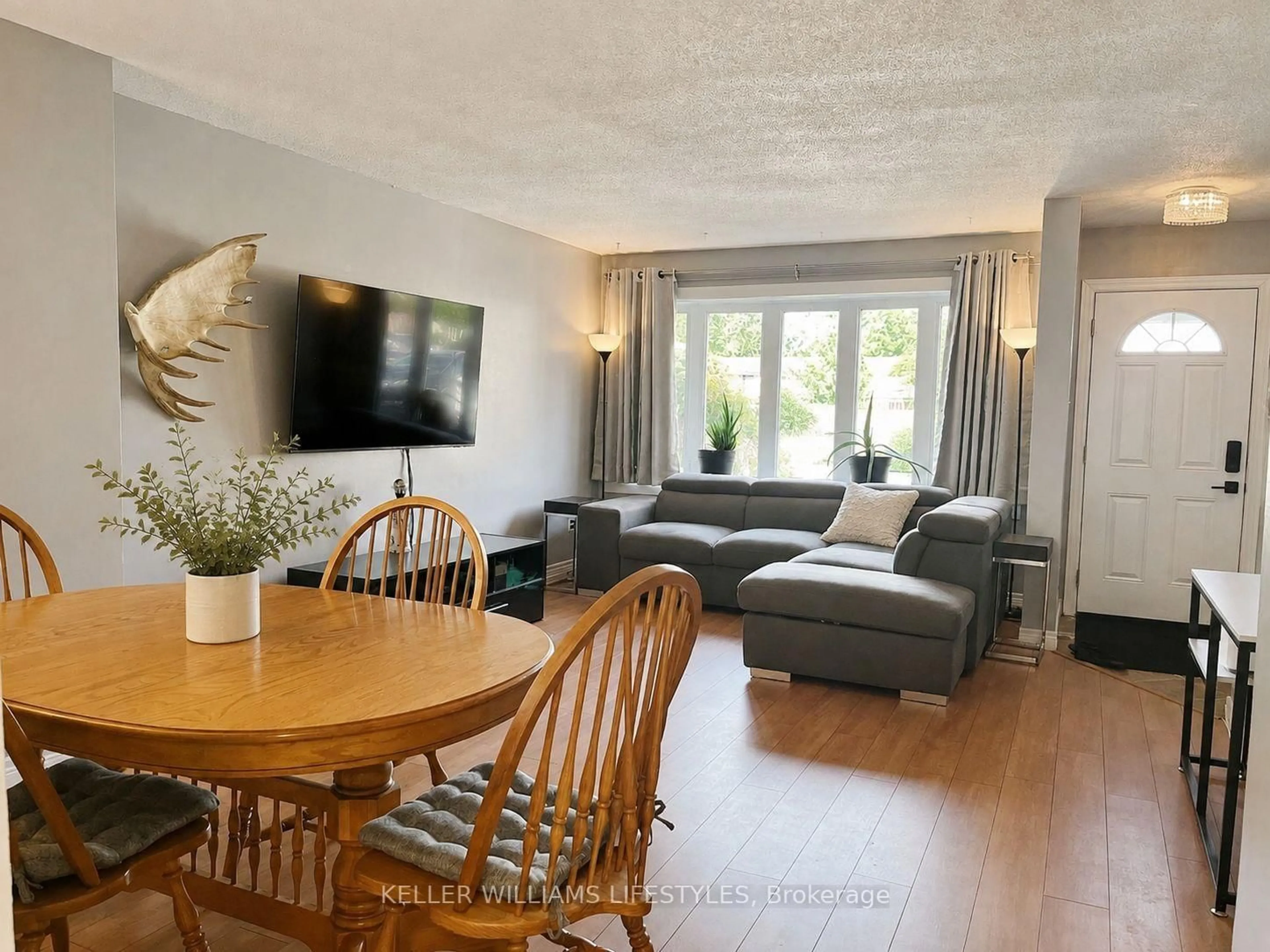 Living room with furniture, wood/laminate floor for 700 EXETER Rd #46, London South Ontario N6E 1L2