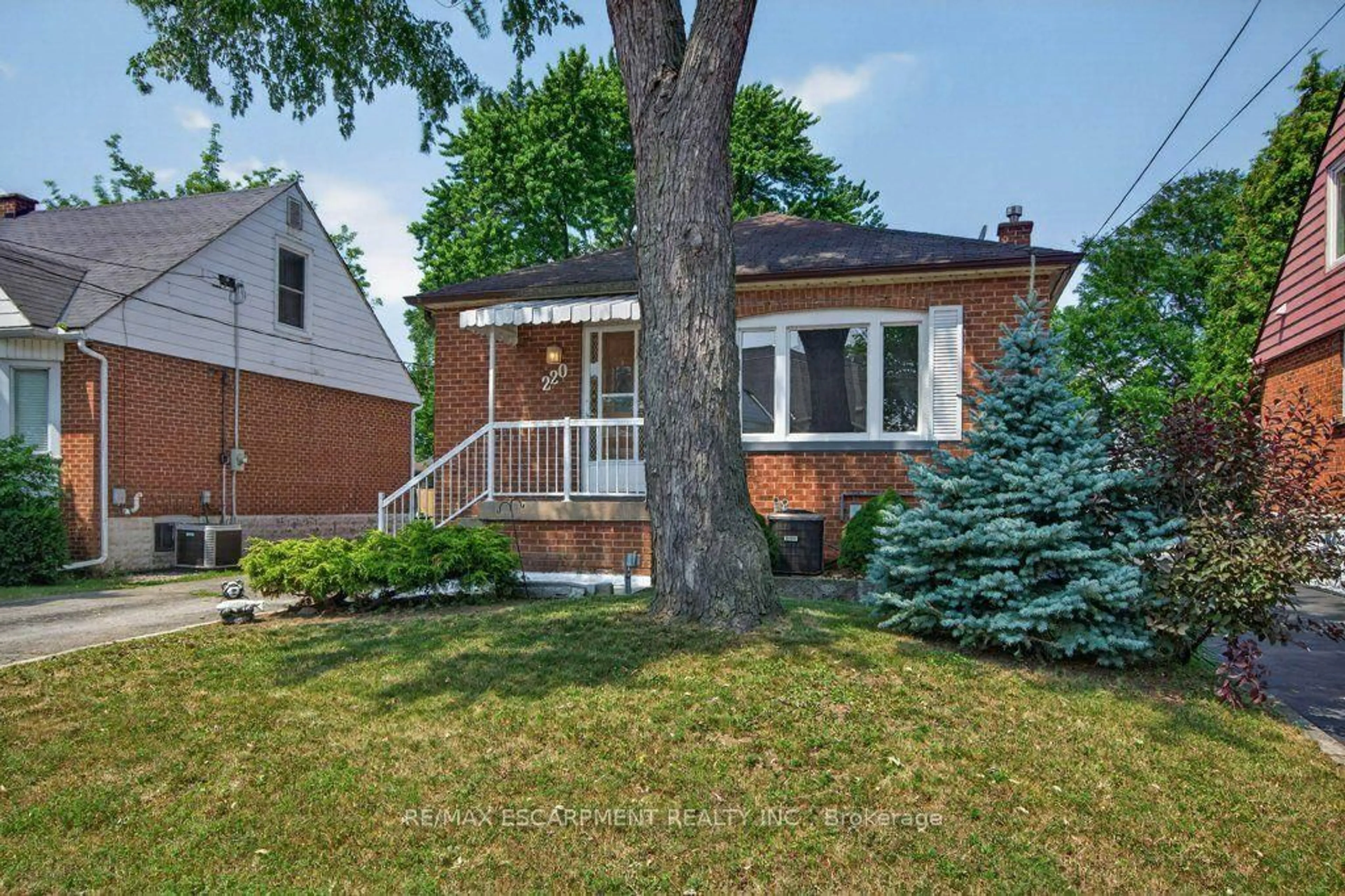 Home with brick exterior material, street for 220 EAST 13TH St, Hamilton Ontario L9A 3Z7