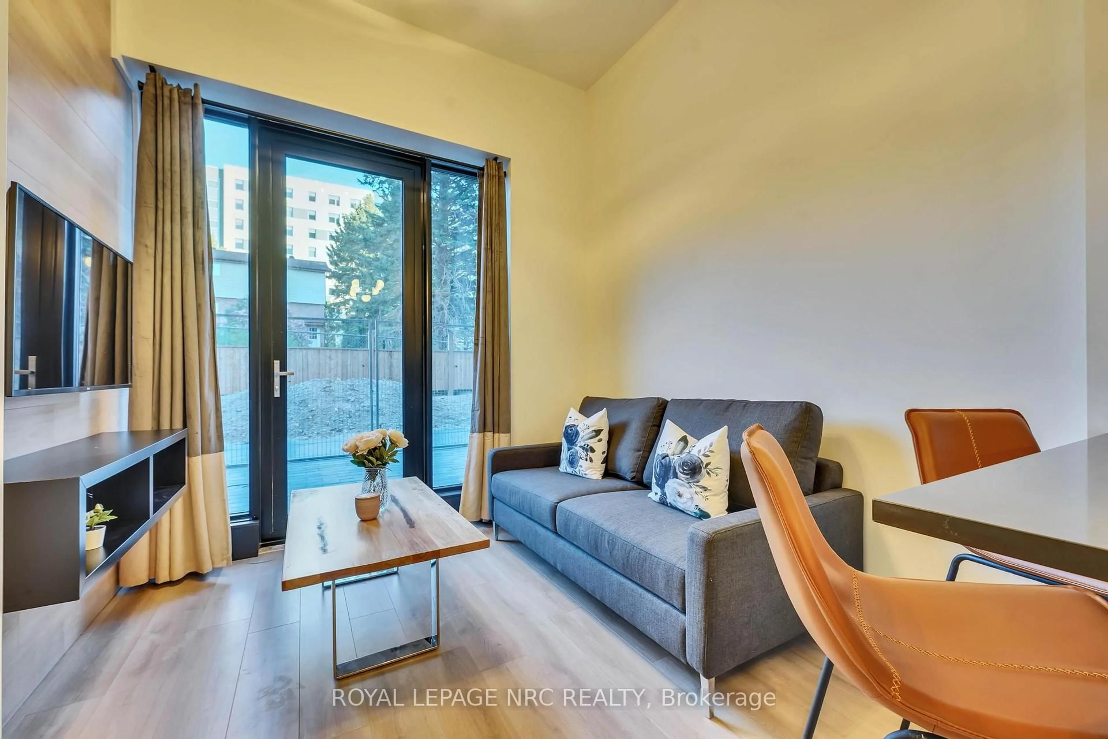 Living room with furniture, wood/laminate floor for 145 Columbia St #133, Waterloo Ontario N2L 0K7