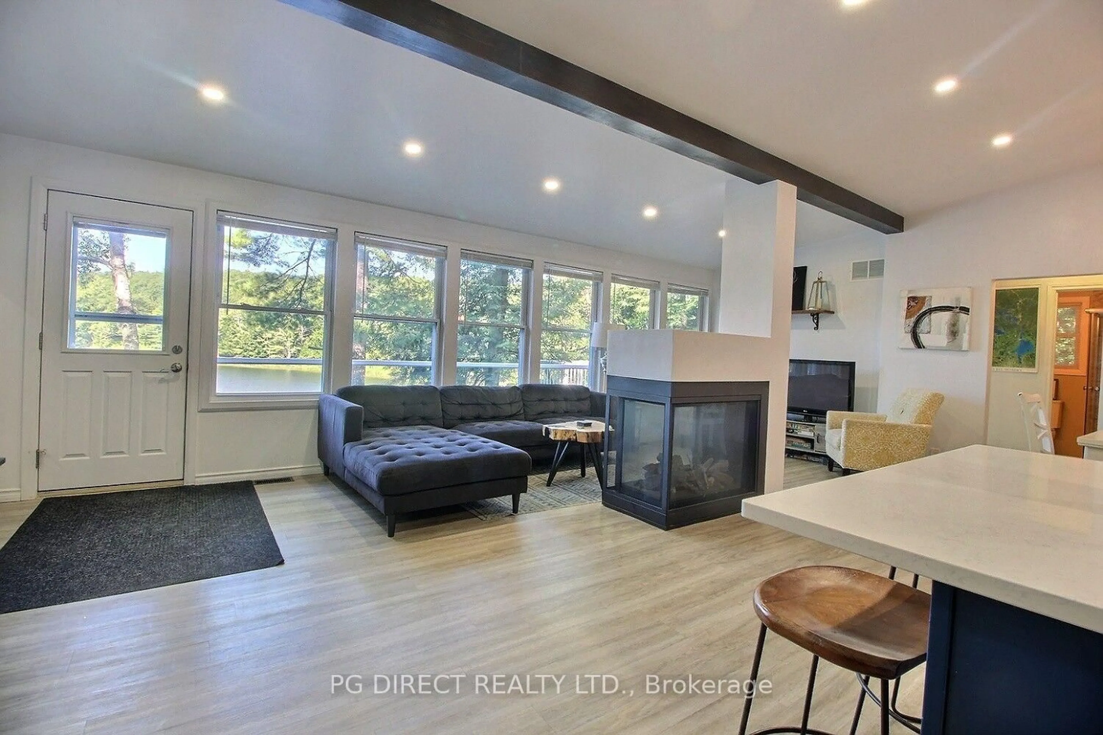 Living room with furniture, wood/laminate floor for 164 Iroquois Rd, Georgian Bay Ontario L0K 1S0