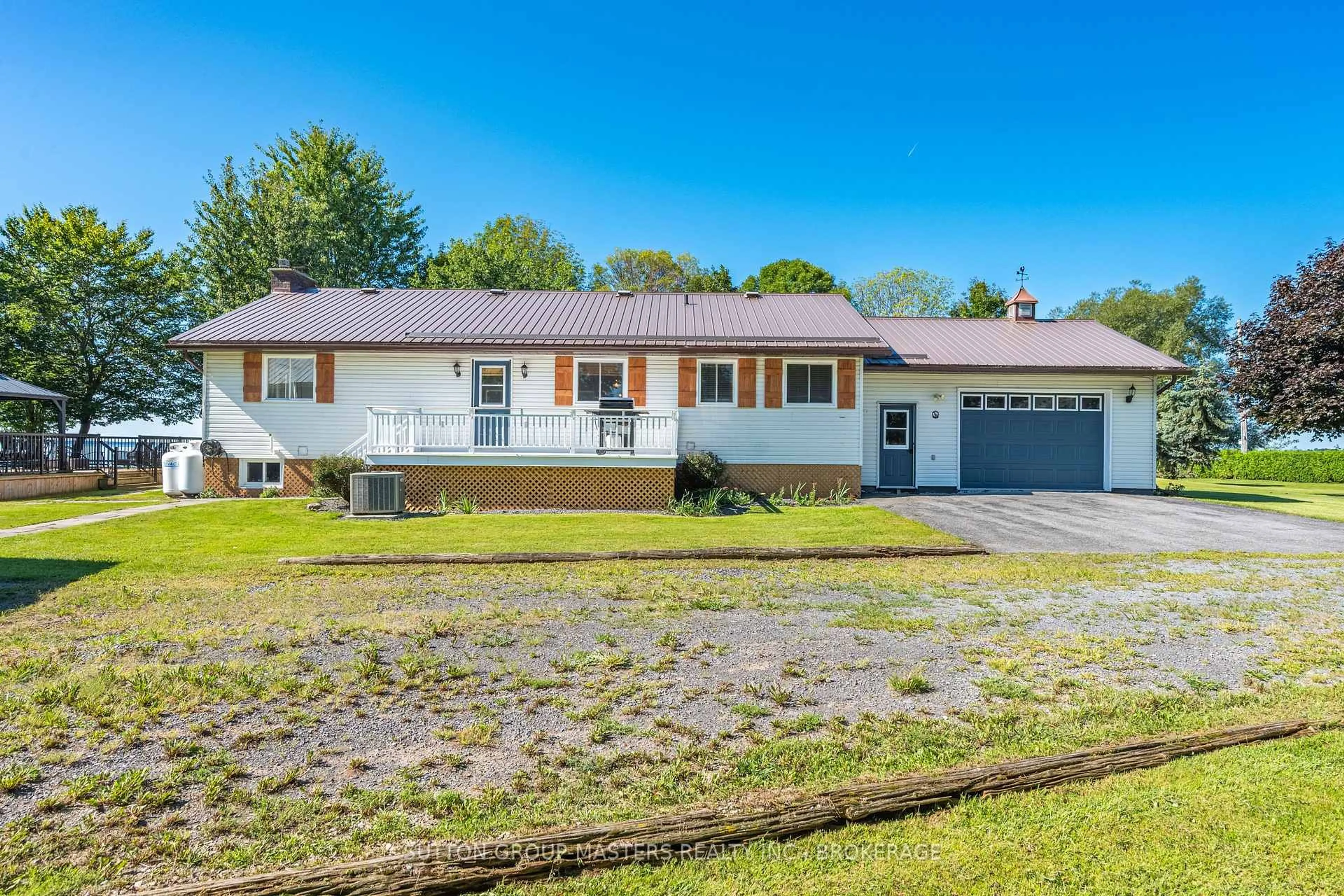 Home with vinyl exterior material, street for 175 Pleasure Pt. Lane, Wolfe Island Ontario K0H 2Y0