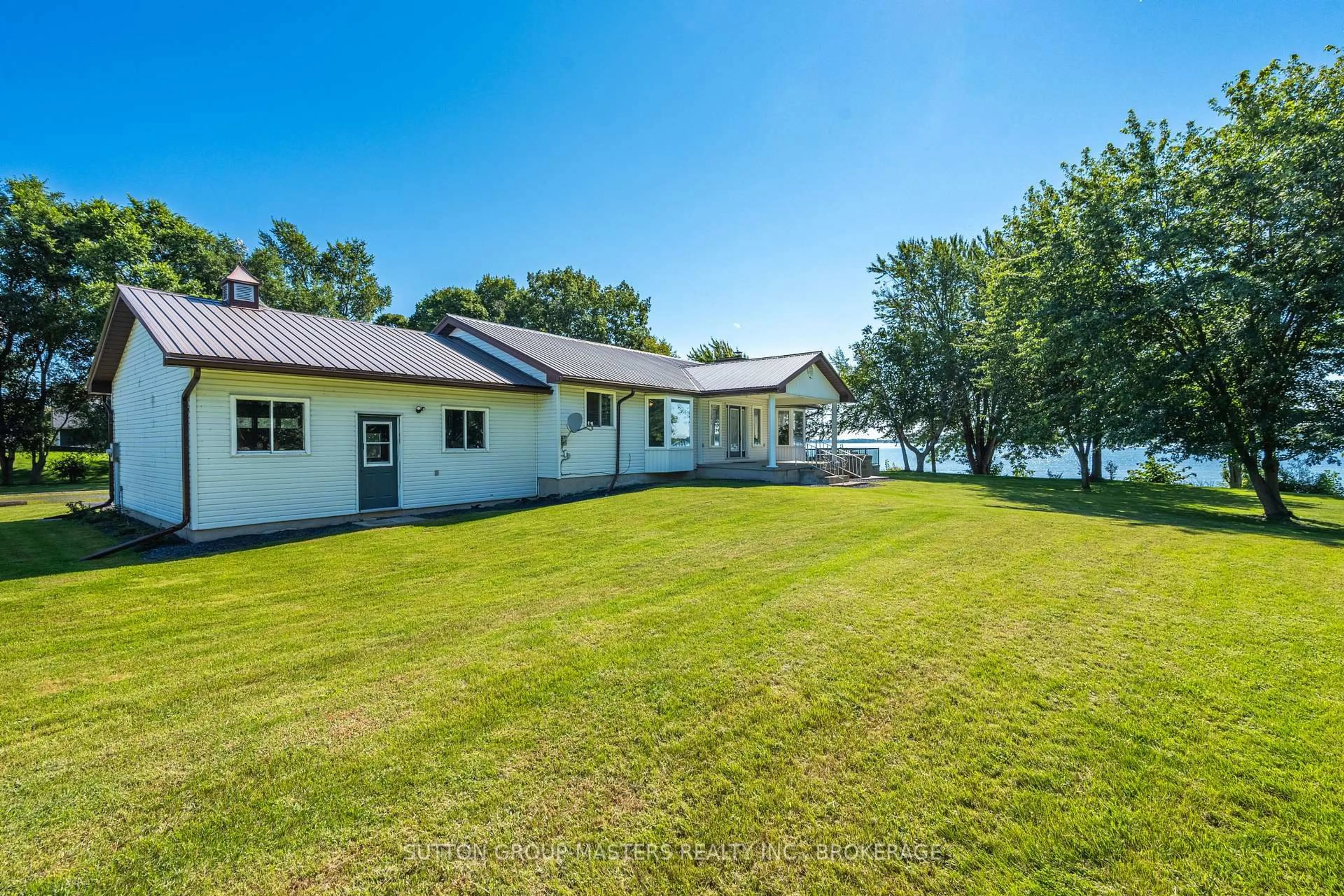 A pic from outside/outdoor area/front of a property/back of a property/a pic from drone, water/lake/river/ocean view for 175 Pleasure Pt. Lane, Wolfe Island Ontario K0H 2Y0