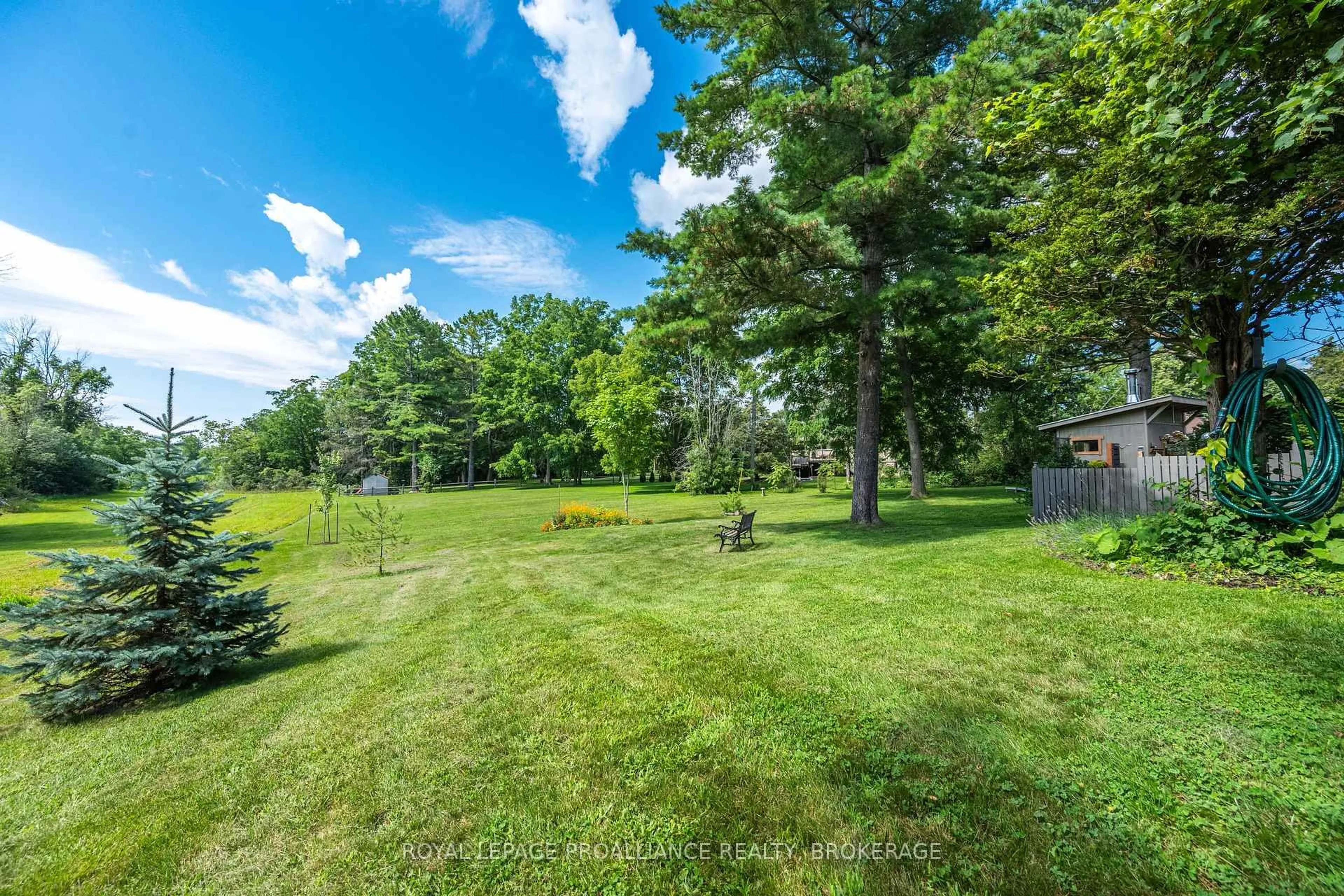 A pic from outside/outdoor area/front of a property/back of a property/a pic from drone, forest/trees view for 330 Elmwood Dr, Gananoque Ontario K7G 1P1