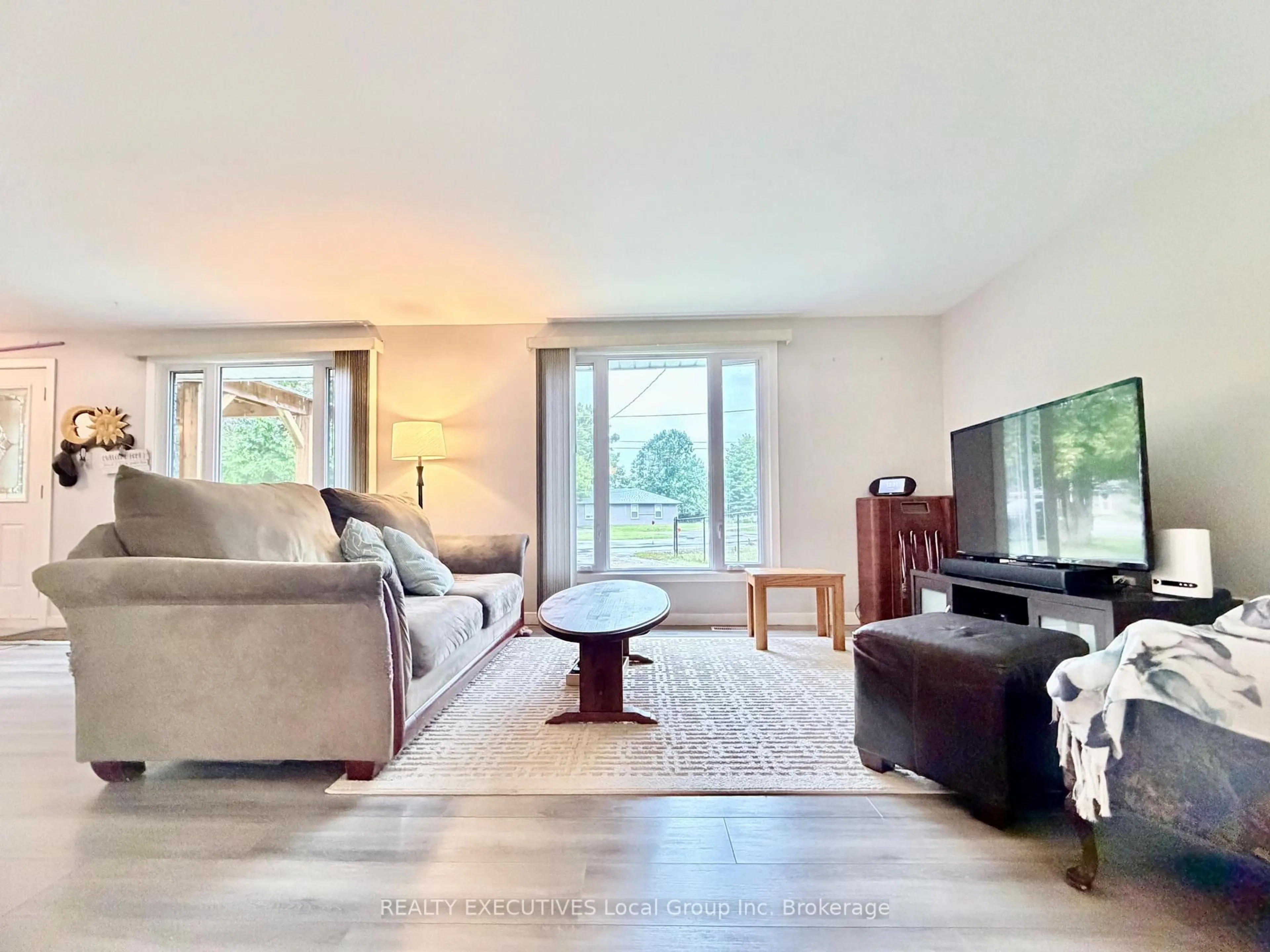 Living room with furniture, wood/laminate floor for 5 Ralph Pl, North Bay Ontario P1A 1L3