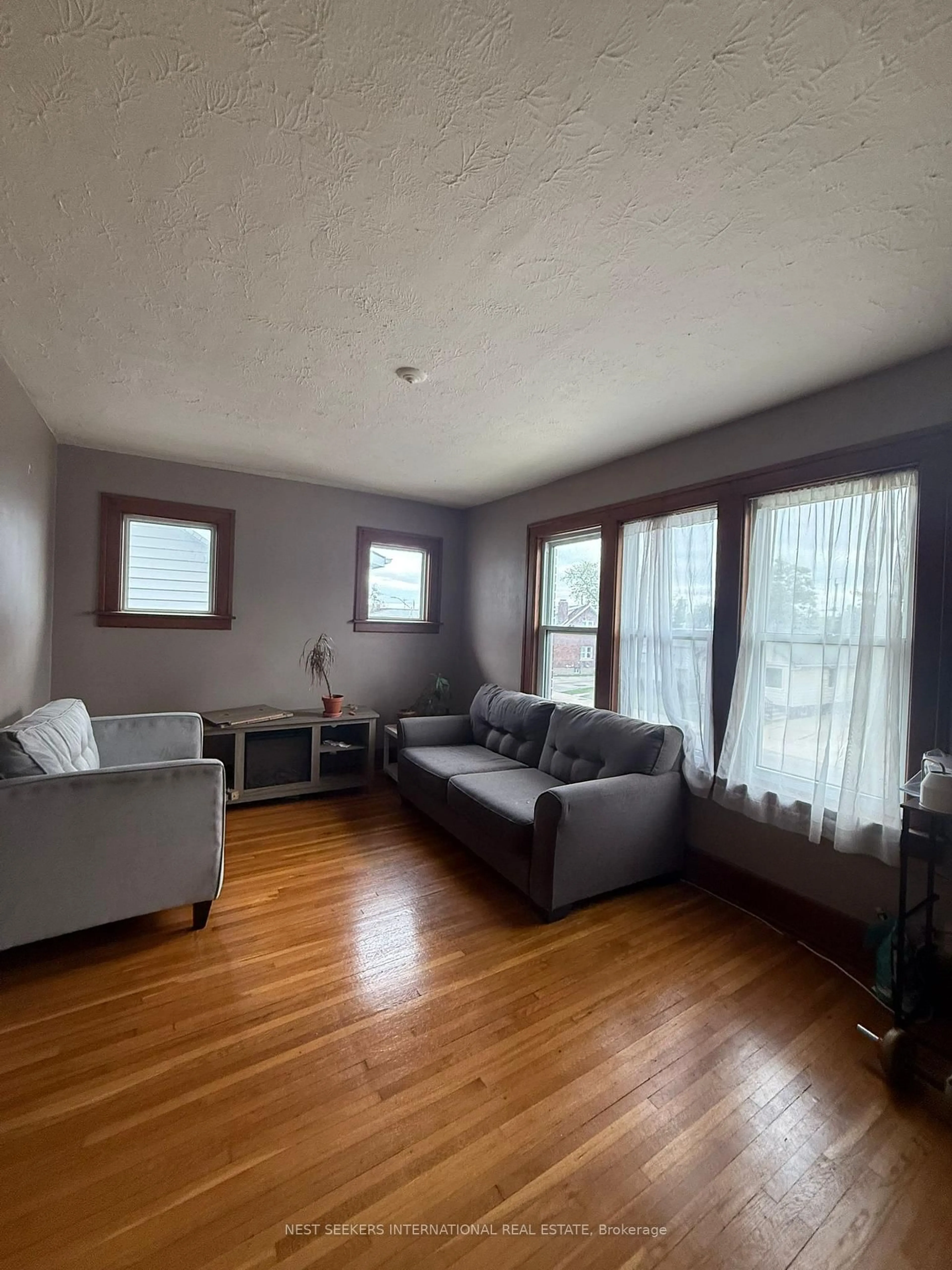 Living room with furniture, wood/laminate floor for 2257-59 Howard Ave, Windsor Ontario N8X 3V2