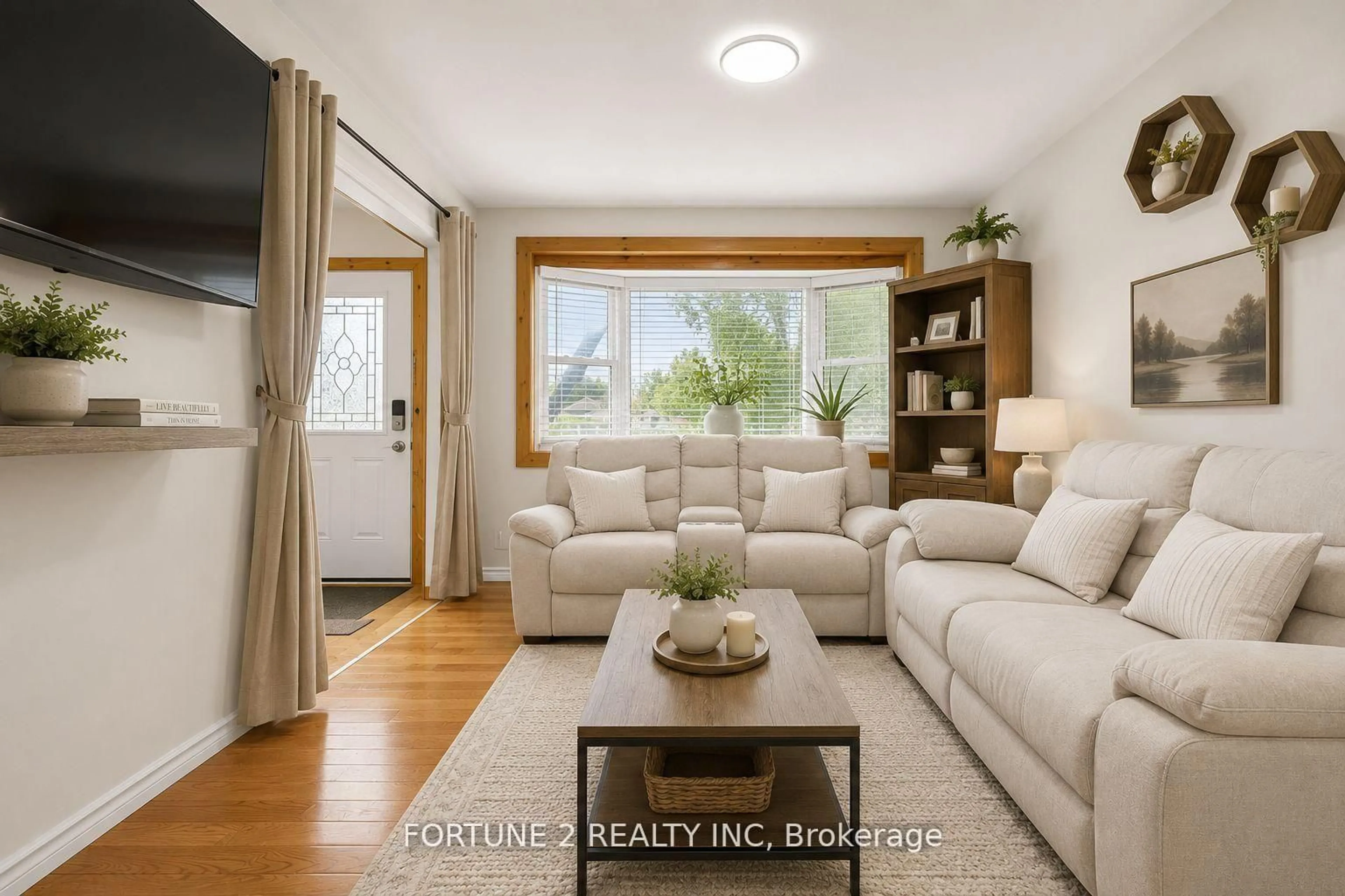 Living room with furniture, wood/laminate floor for 570 Pall Mall St, London East Ontario N5Y 2Z7