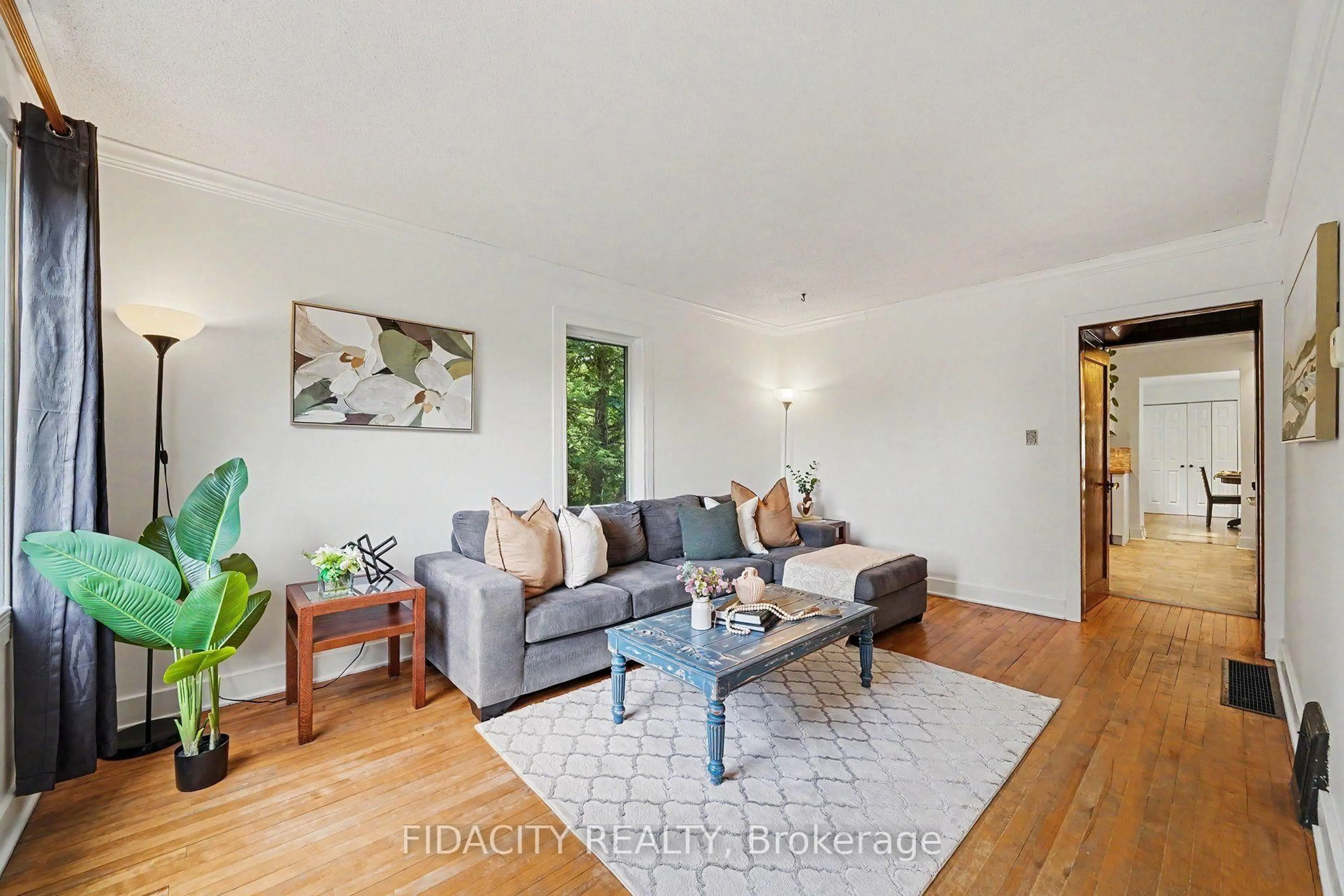 Living room with furniture, wood/laminate floor for 6811 Flewellyn Rd, Ottawa Ontario K2S 1B6