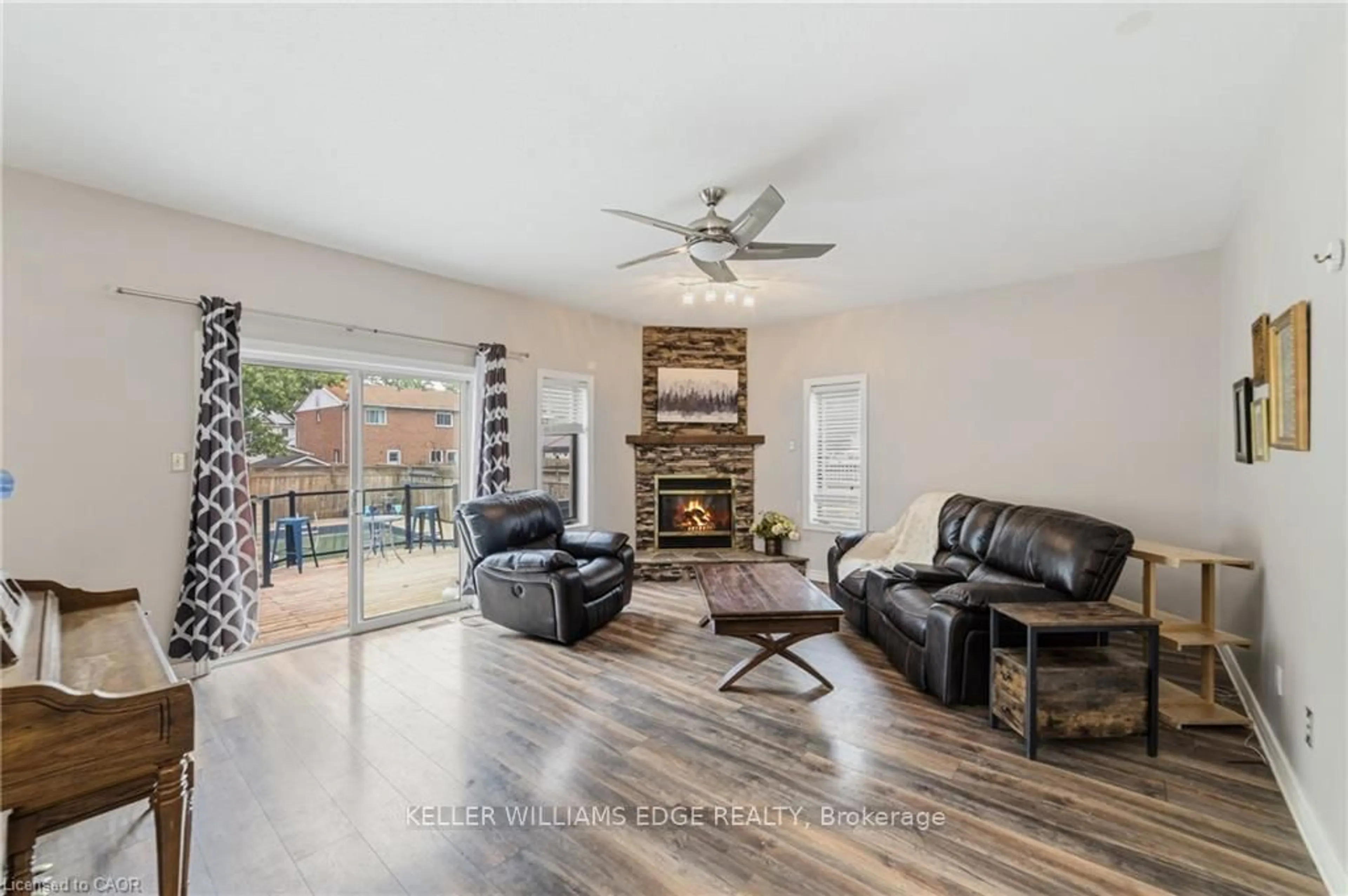 Living room with furniture, wood/laminate floor for 32 Clench Ave, Brantford Ontario N3T 1B6