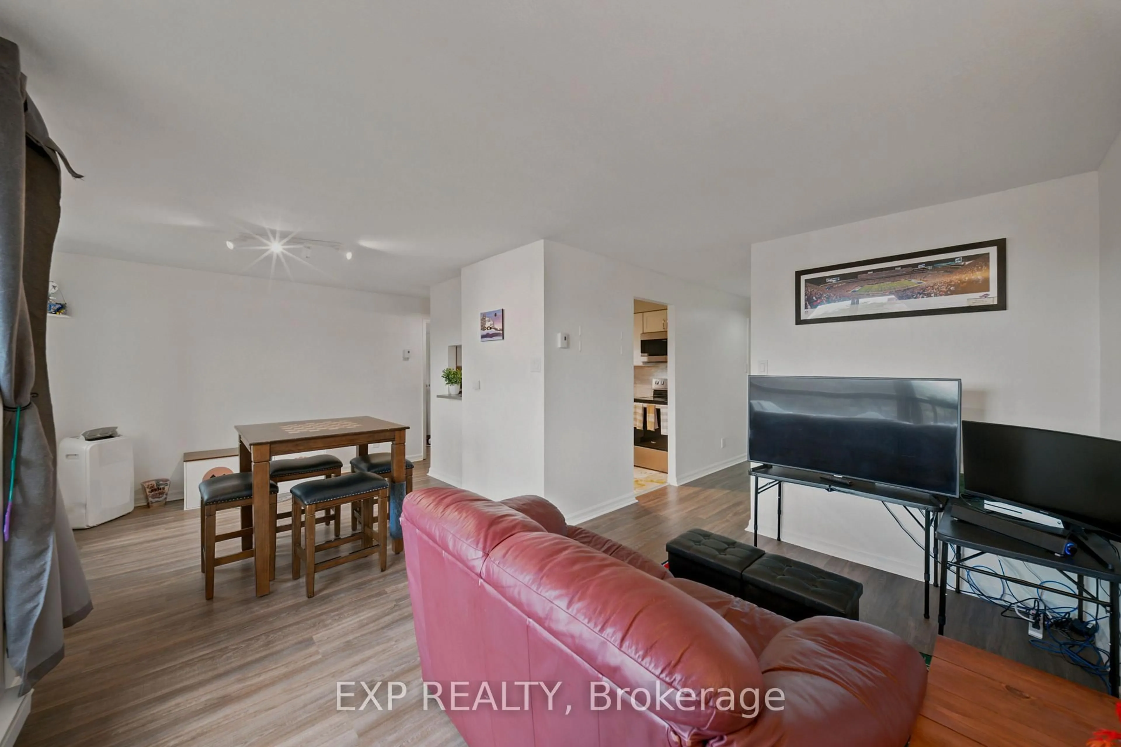Living room with furniture, wood/laminate floor for 222 Guigues Ave #401, Ottawa Ontario K1N 5J2