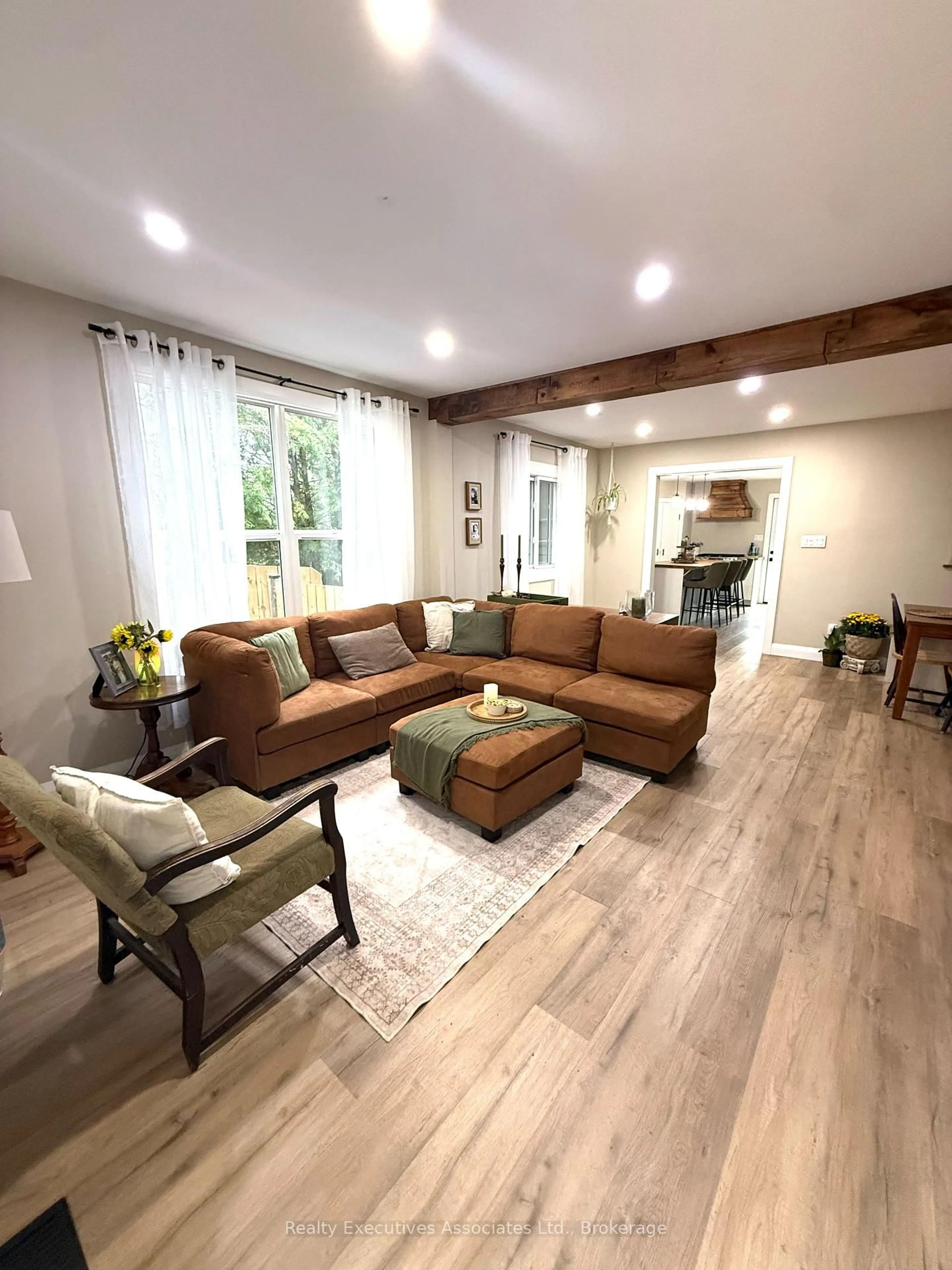 Living room with furniture, wood/laminate floor for 909 Mount Pleasant Rd, Cavan Monaghan Ontario L0A 1C0