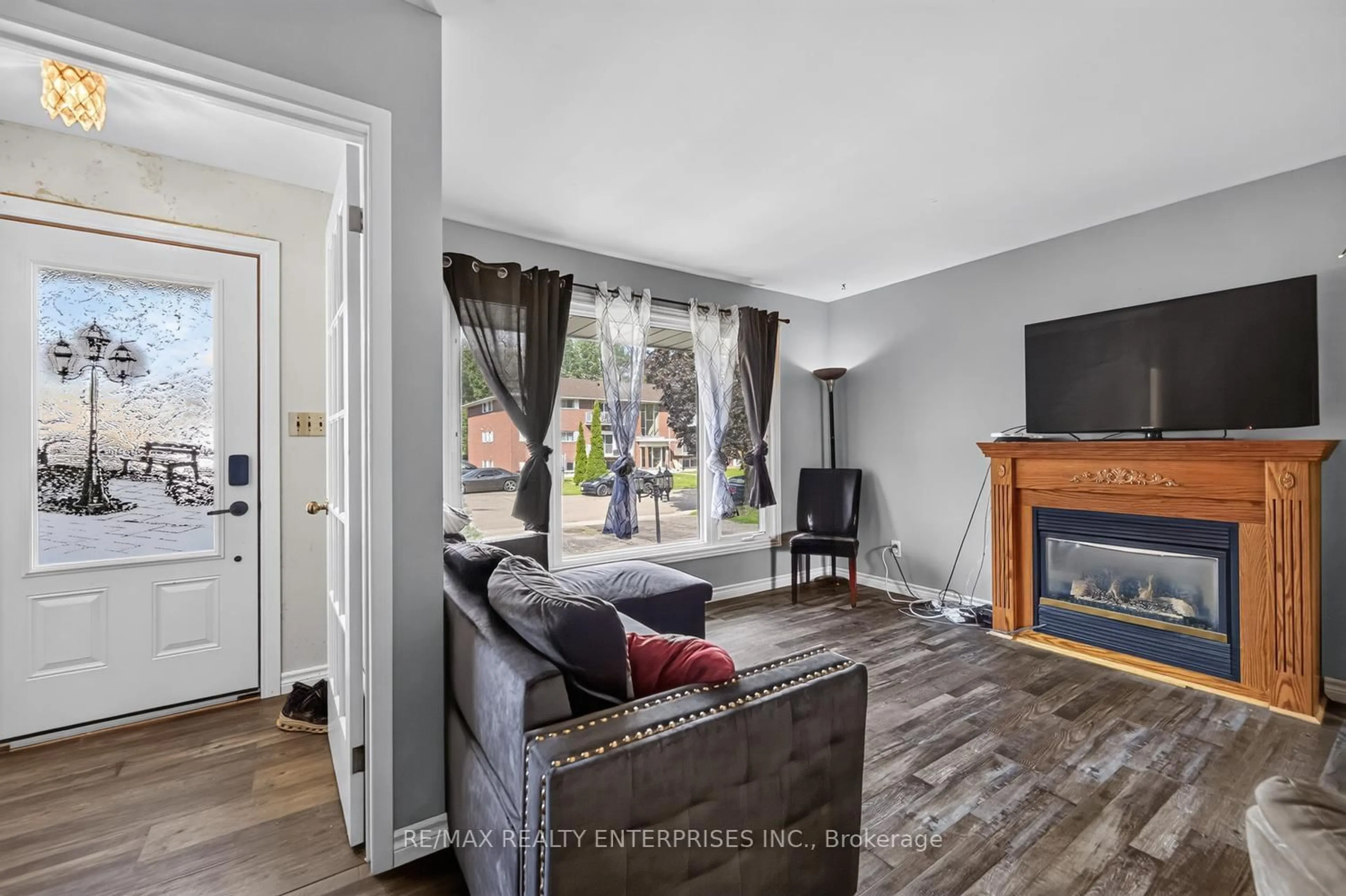 Living room with furniture, wood/laminate floor for 855 Howe Terr, Prescott Ontario K0E 1T0