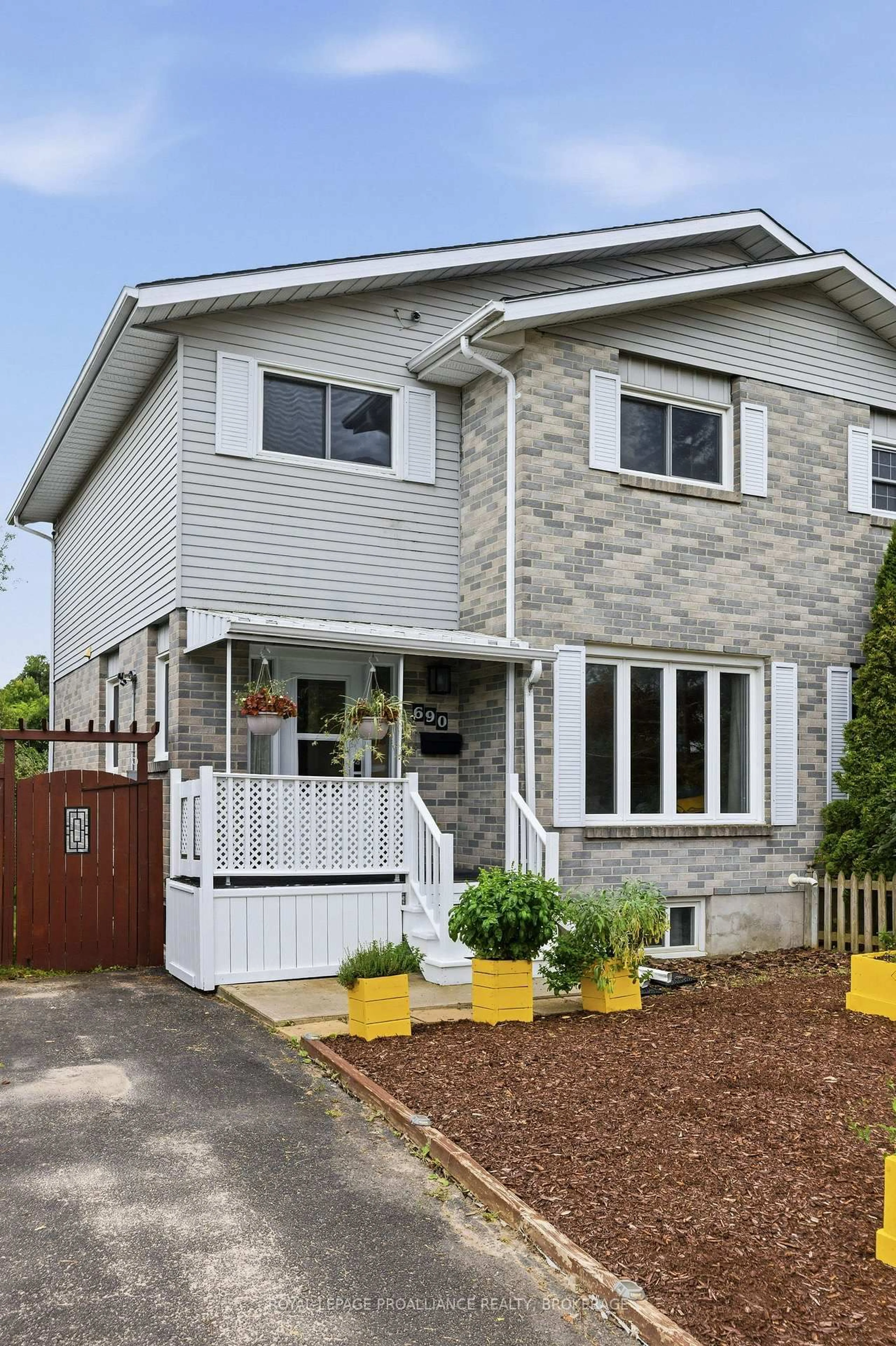 Home with vinyl exterior material, street for 690 Davis Dr, Kingston Ontario K7M 7X3