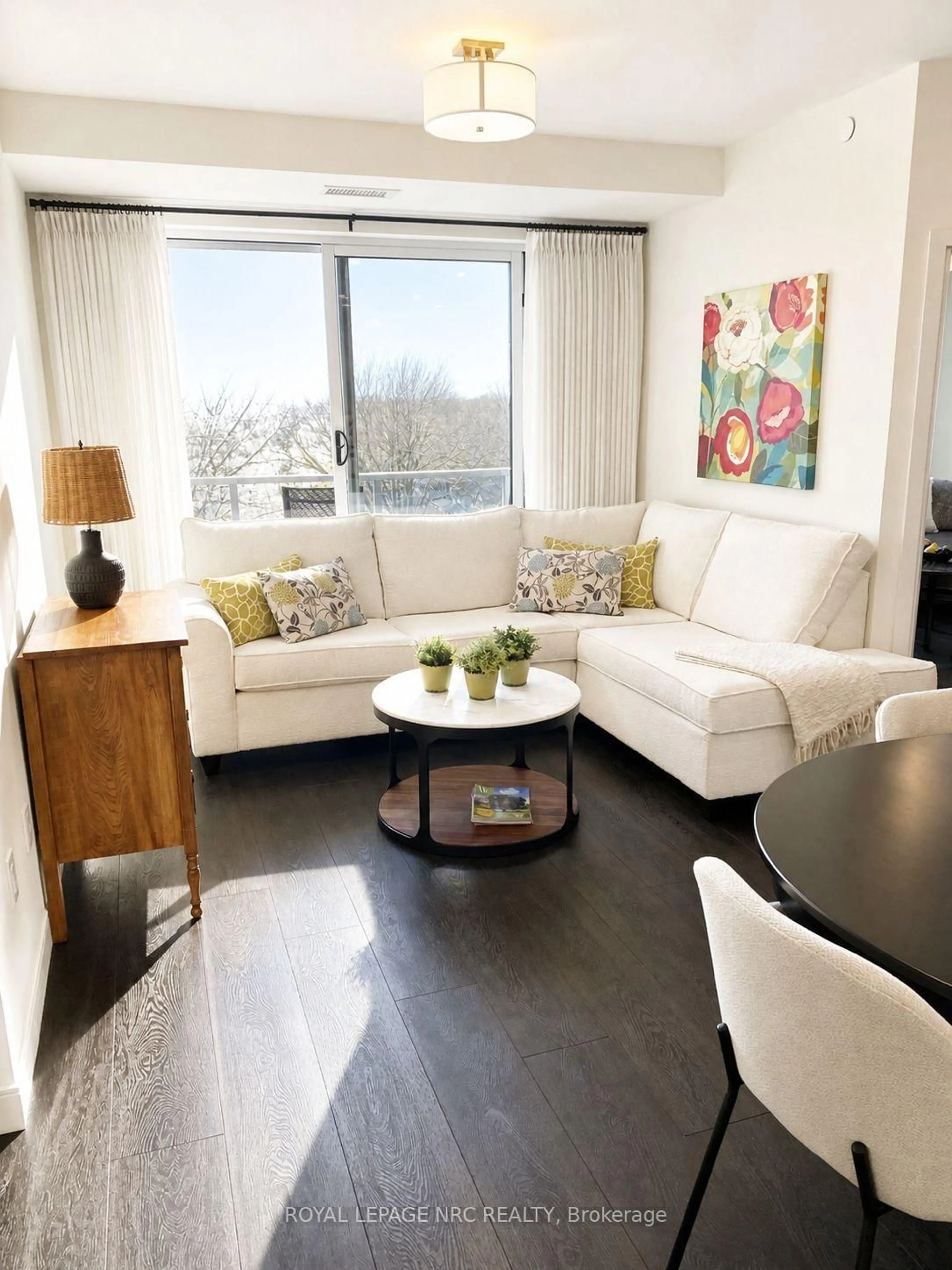Living room with furniture, wood/laminate floor for 118 West St #604, Port Colborne Ontario L3K 4C9
