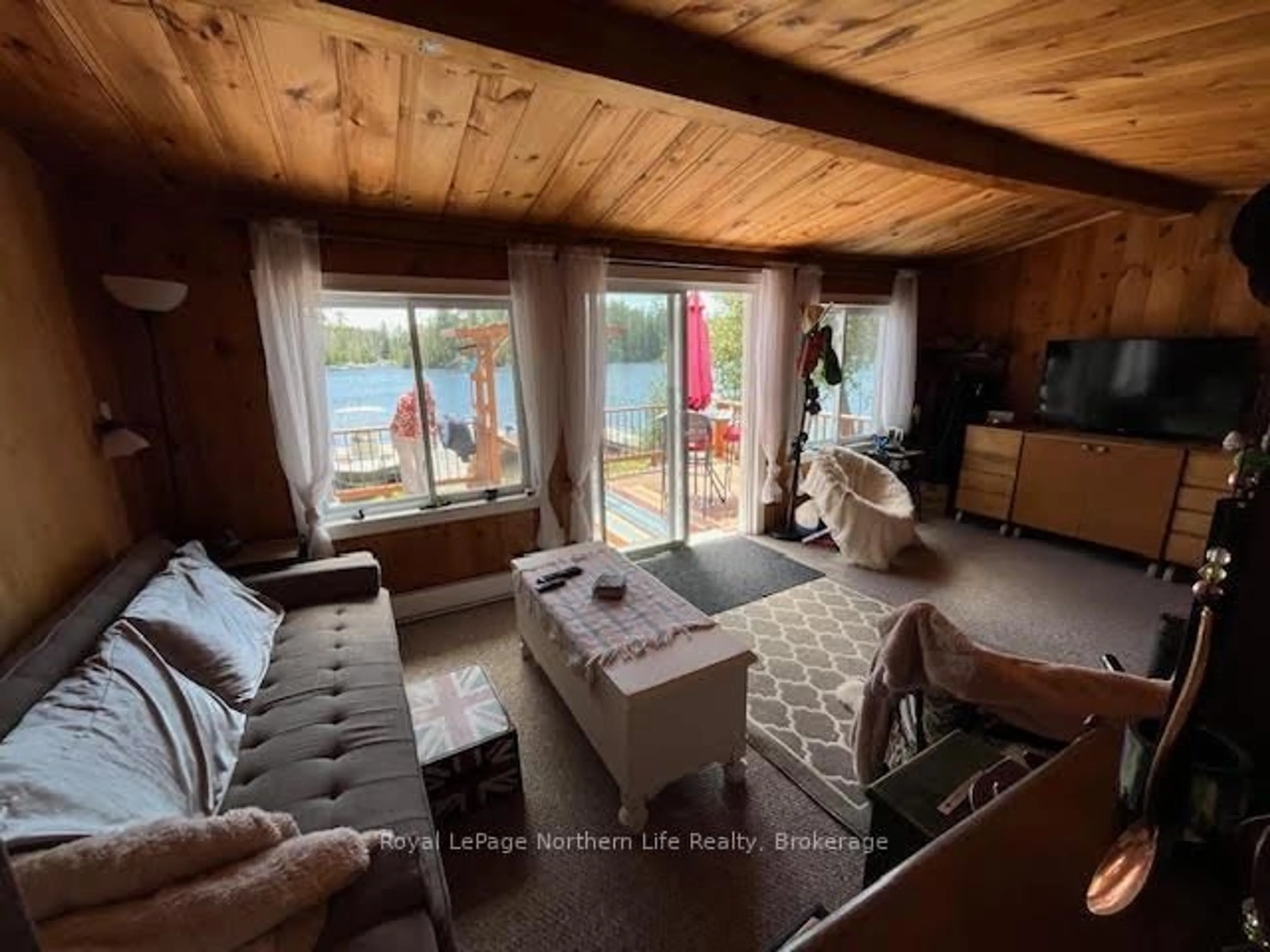 Living room with furniture, wood/laminate floor for 166 Lake Temagami Island 27 Island, Temagami Ontario P0H 2H0