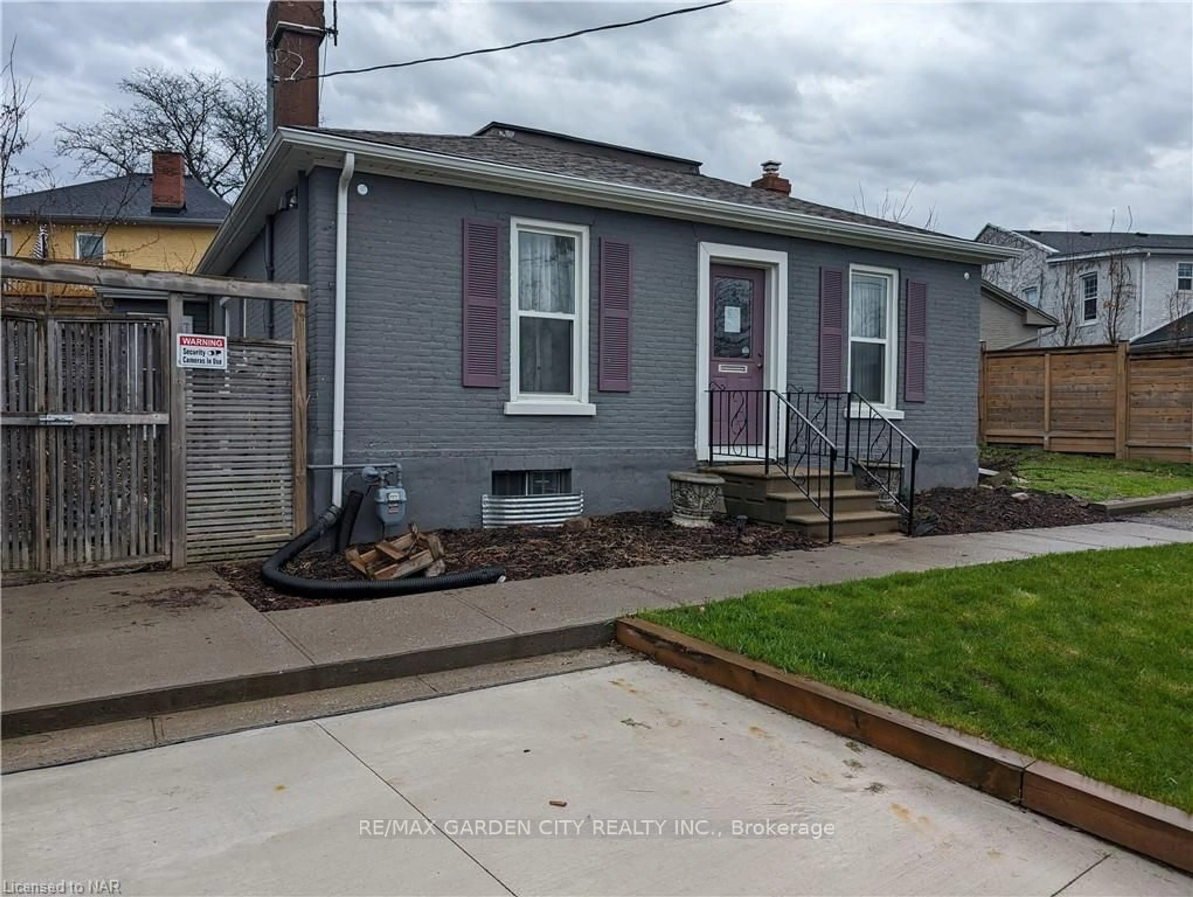 Frontside or backside of a home, the fenced backyard for 28 Lake St, St. Catharines Ontario L2R 5W6