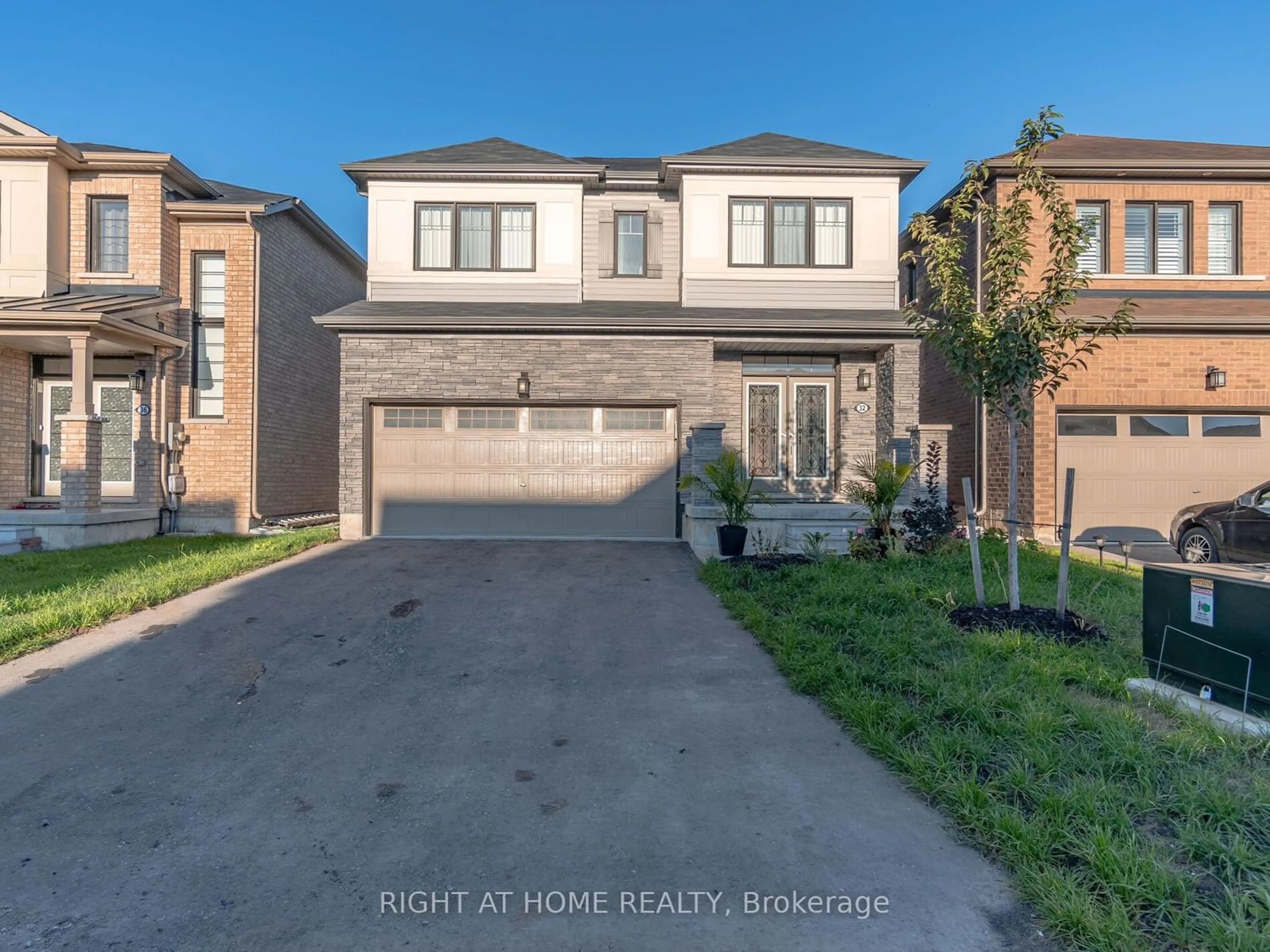 Frontside or backside of a home for 32 July Ave, Hamilton Ontario L8J 0M3