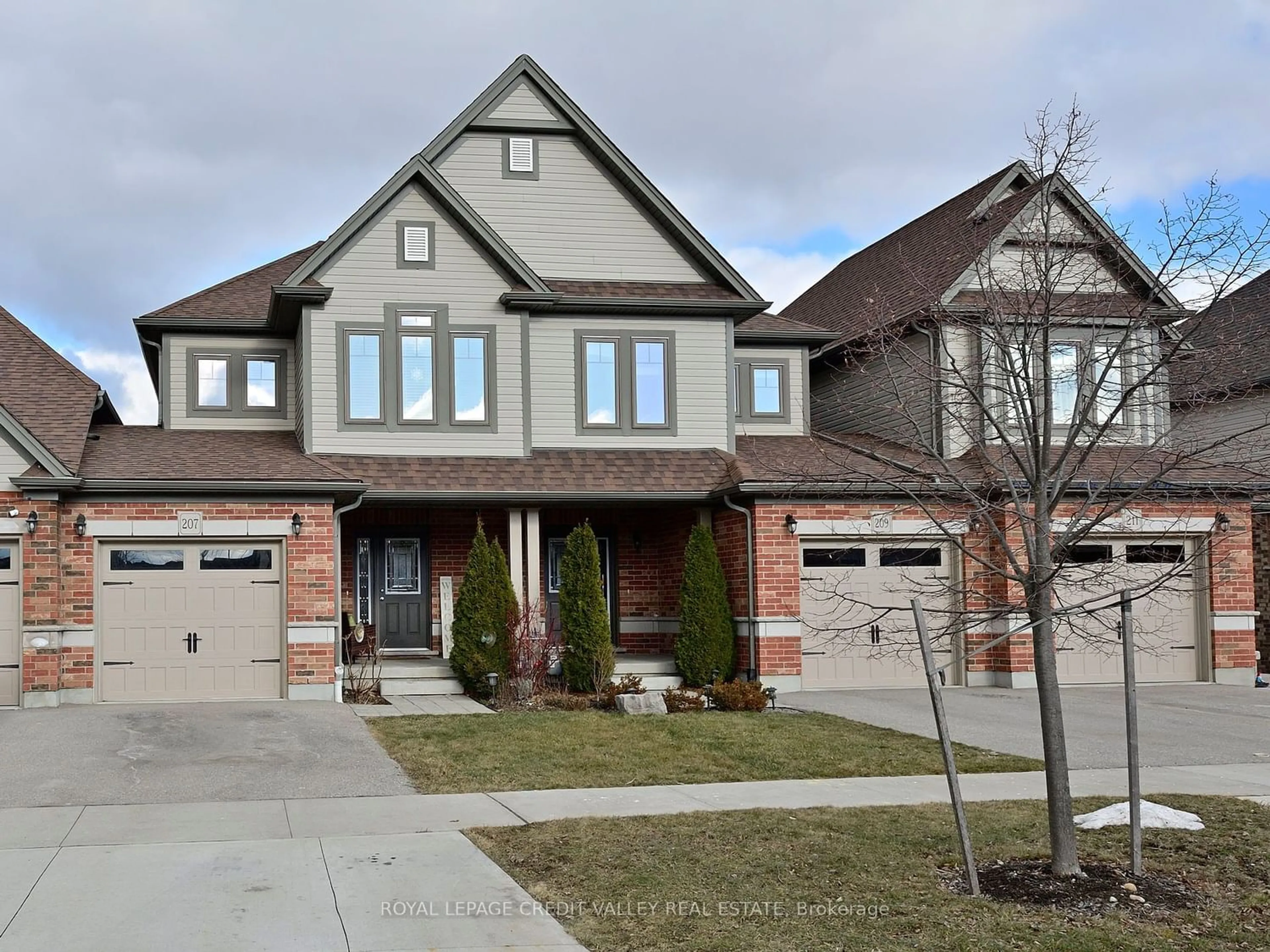 Home with brick exterior material for 207 Eden Oak Tr, Kitchener Ontario N2A 0H6