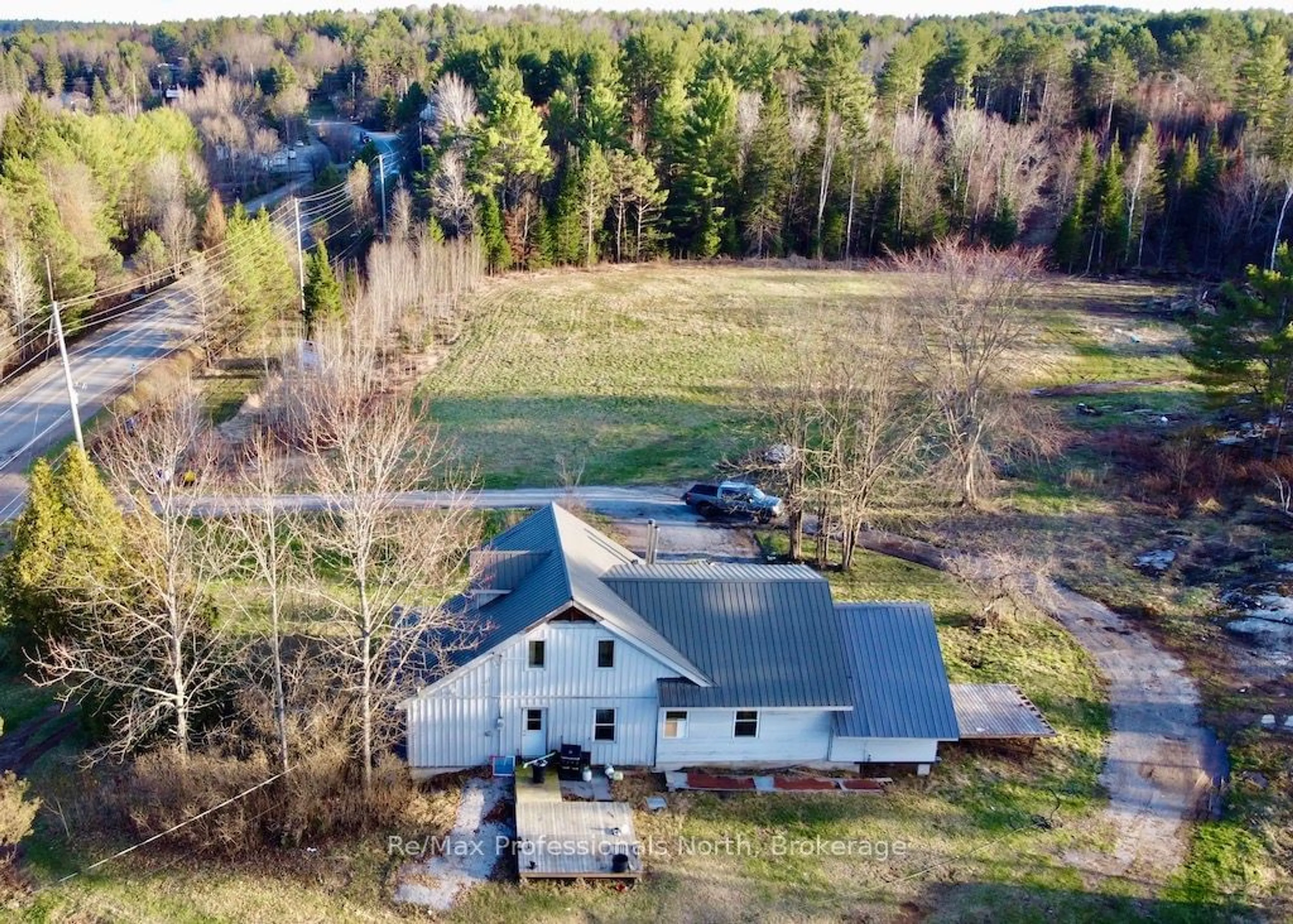 A pic from outside/outdoor area/front of a property/back of a property/a pic from drone, water/lake/river/ocean view for 4177 County Road 121, Minden Hills Ontario K0M 2A0