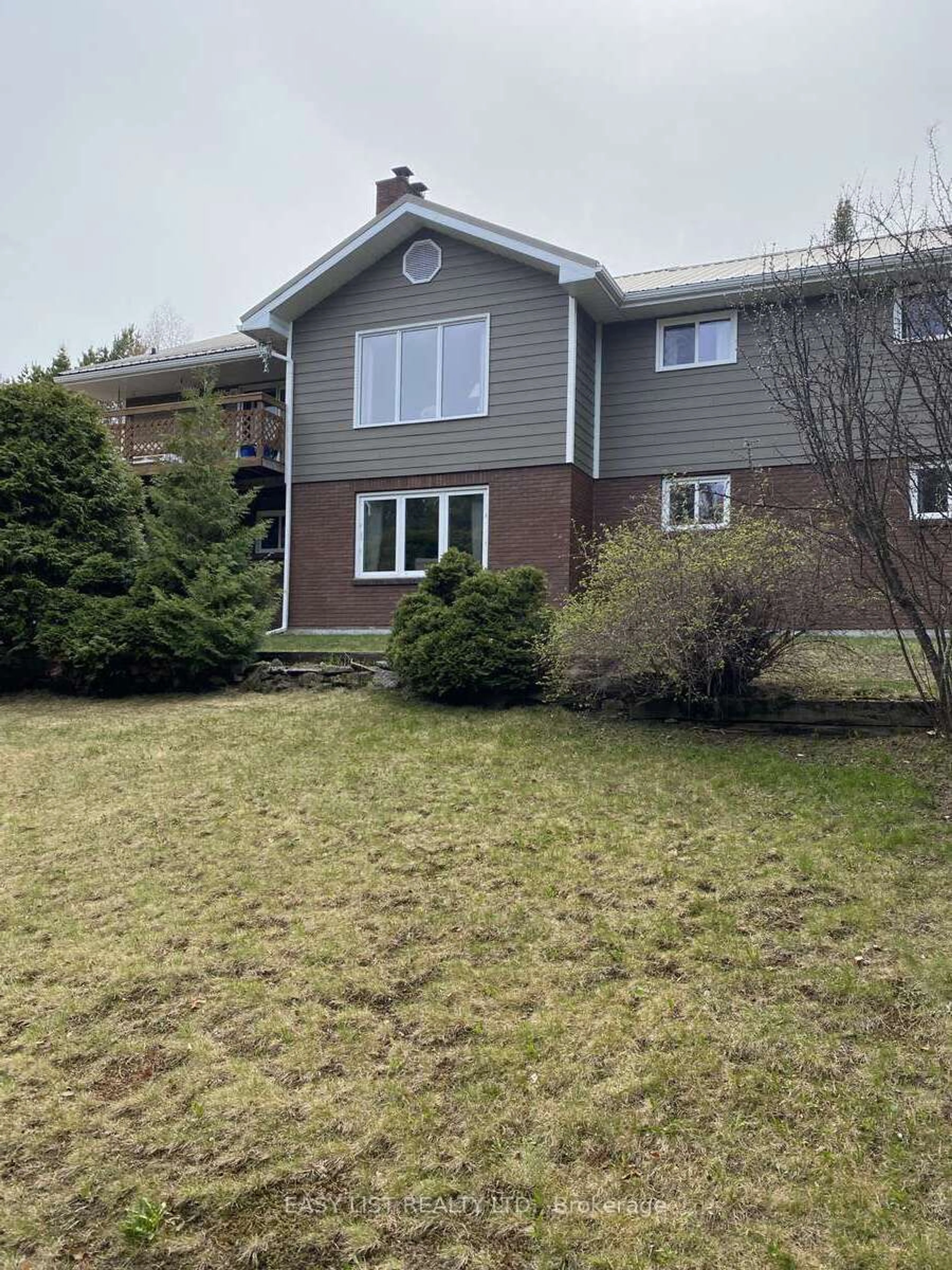 Frontside or backside of a home, the fenced backyard for 14 Cedar Point Dr, Sioux Lookout Ontario P8T 0A7