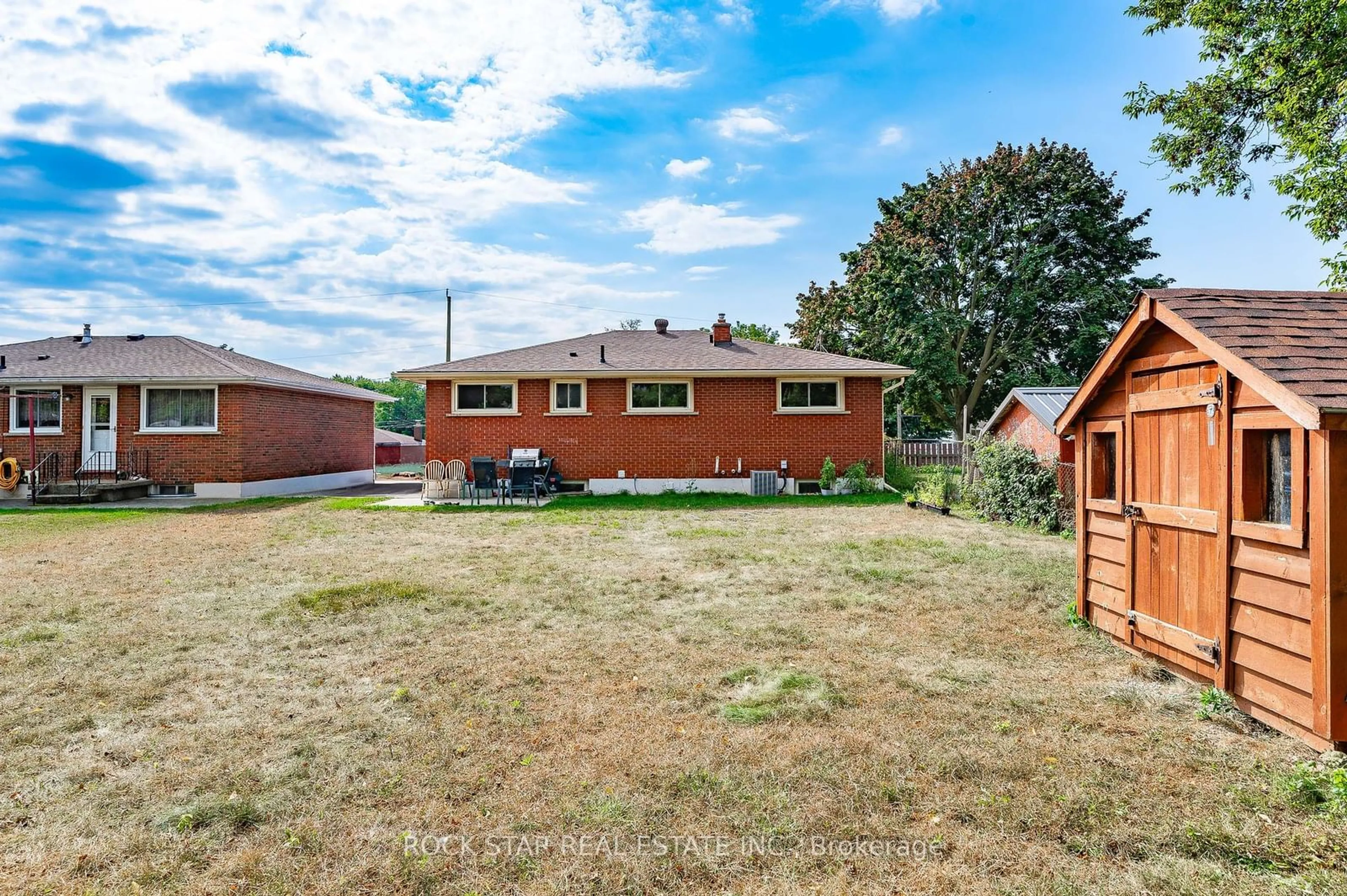 Frontside or backside of a home, the fenced backyard for 236 Bruce St, Brantford Ontario N3S 4Z9