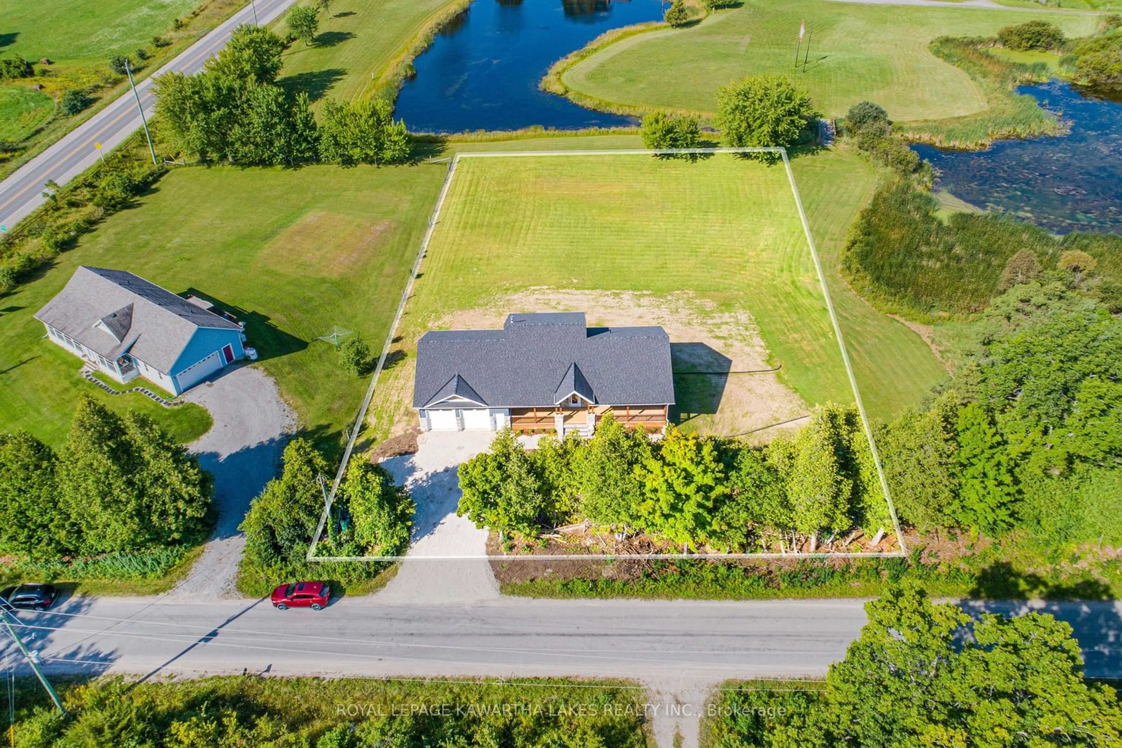 Frontside or backside of a home, the fenced backyard for 33 Coshs Rd, Kawartha Lakes Ontario K0M 1A0