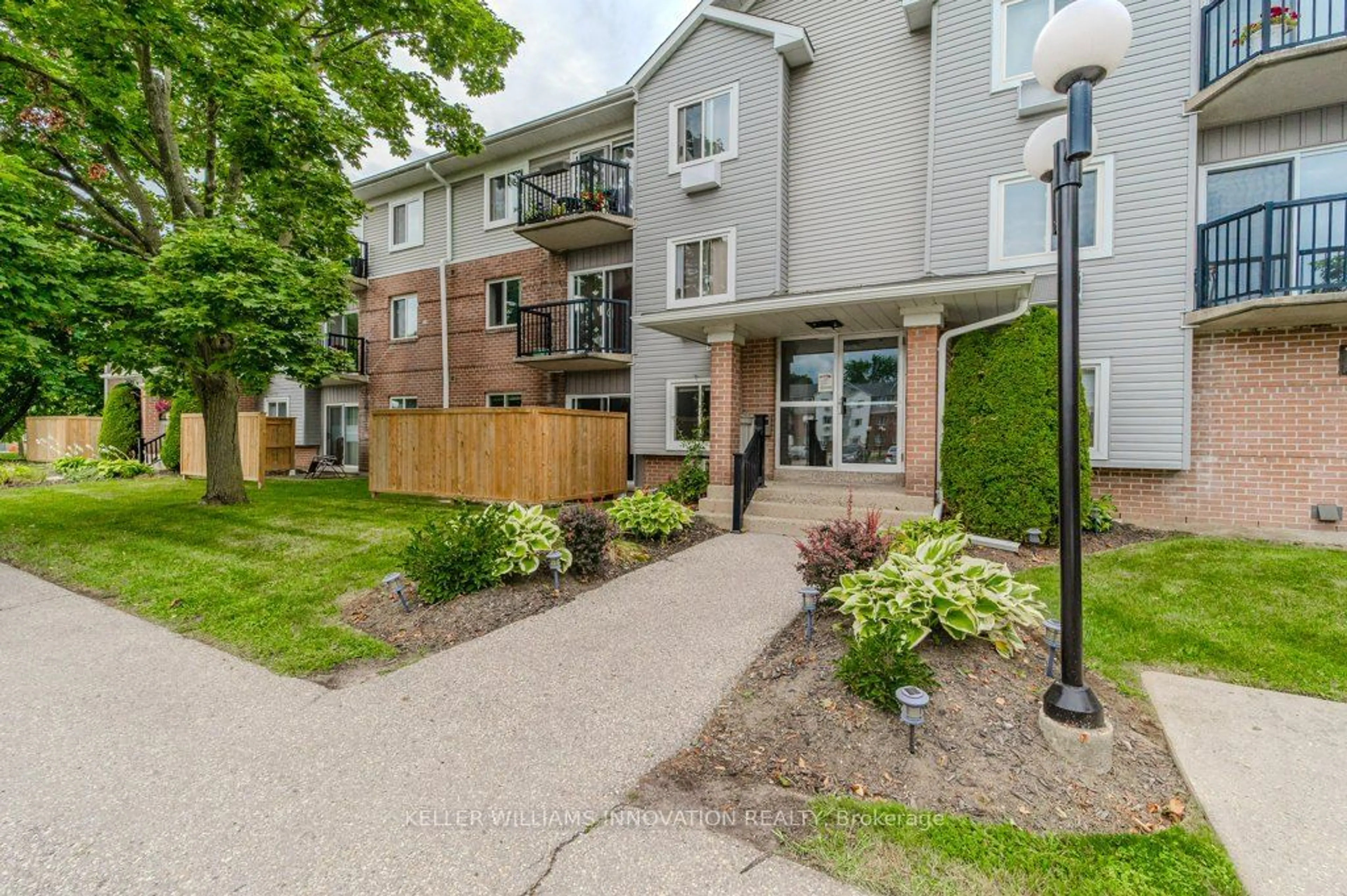 A pic from exterior of the house or condo, the fenced backyard for 276 Eiwo Crt #305, Waterloo Ontario N2K 3M6