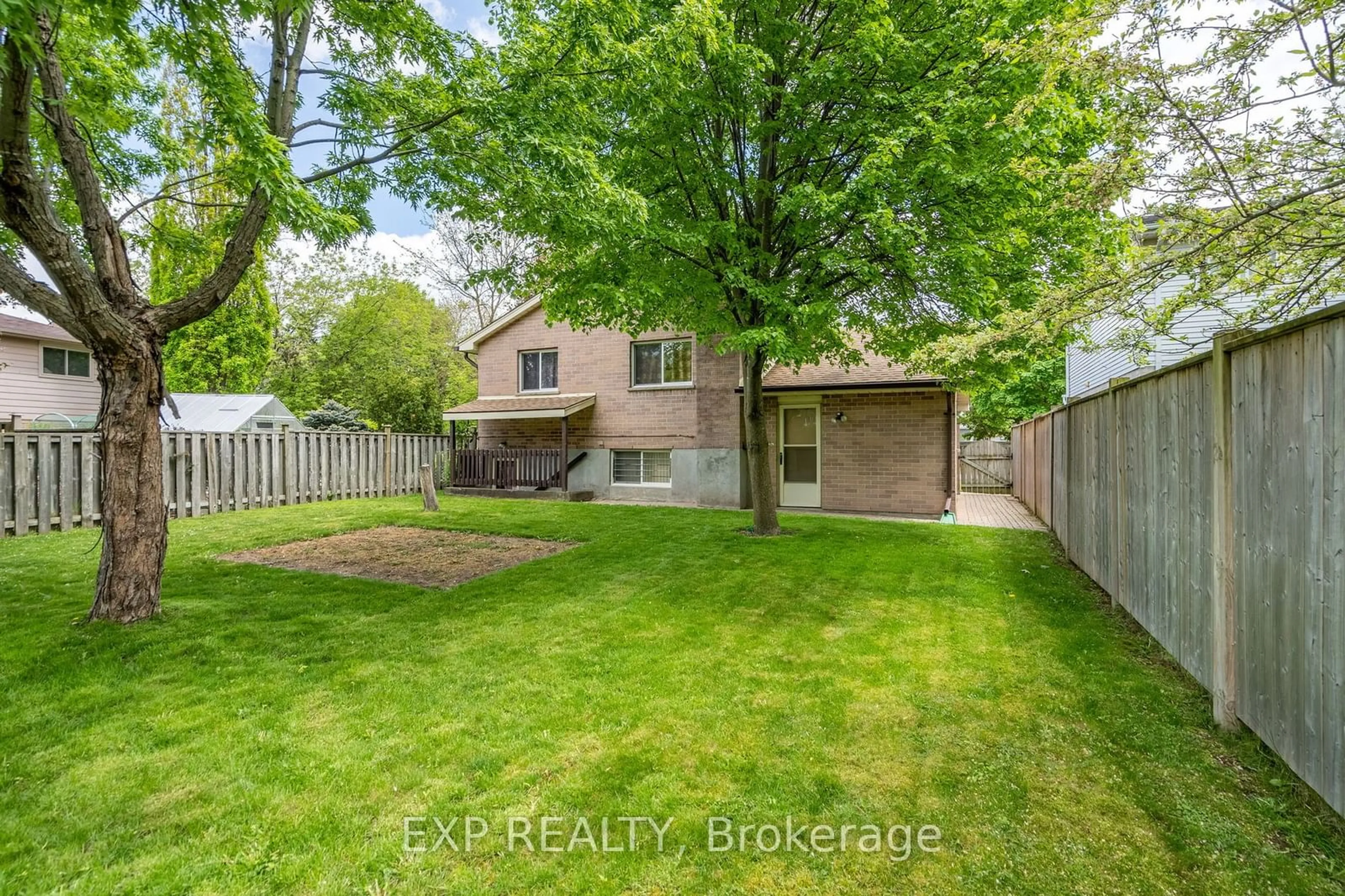 Frontside or backside of a home, the fenced backyard for 107 River Run Terr, London Ontario N5W 5Y9