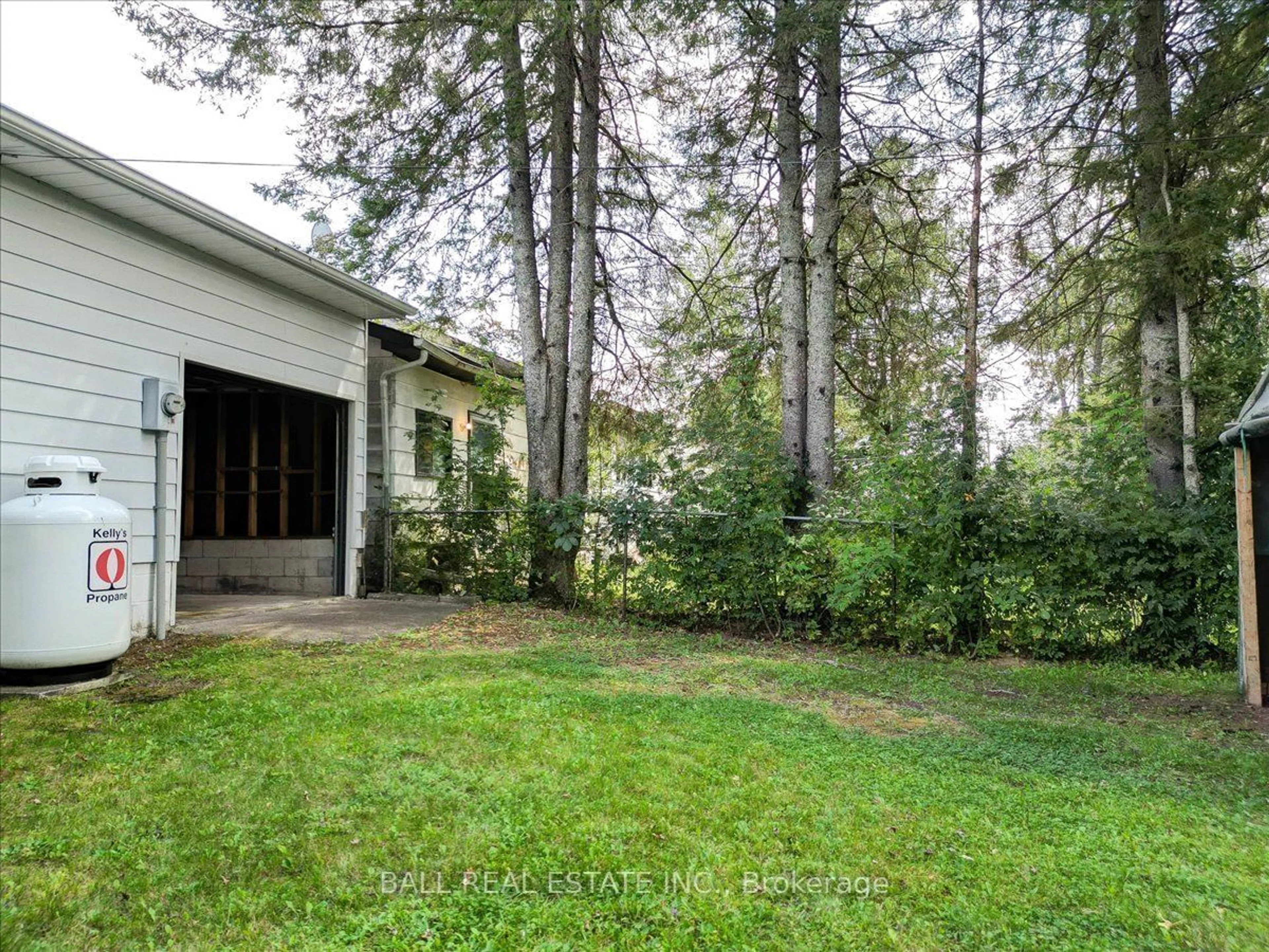 Frontside or backside of a home, the fenced backyard for 12 Great Oak St, Highlands East Ontario K0L 1M0