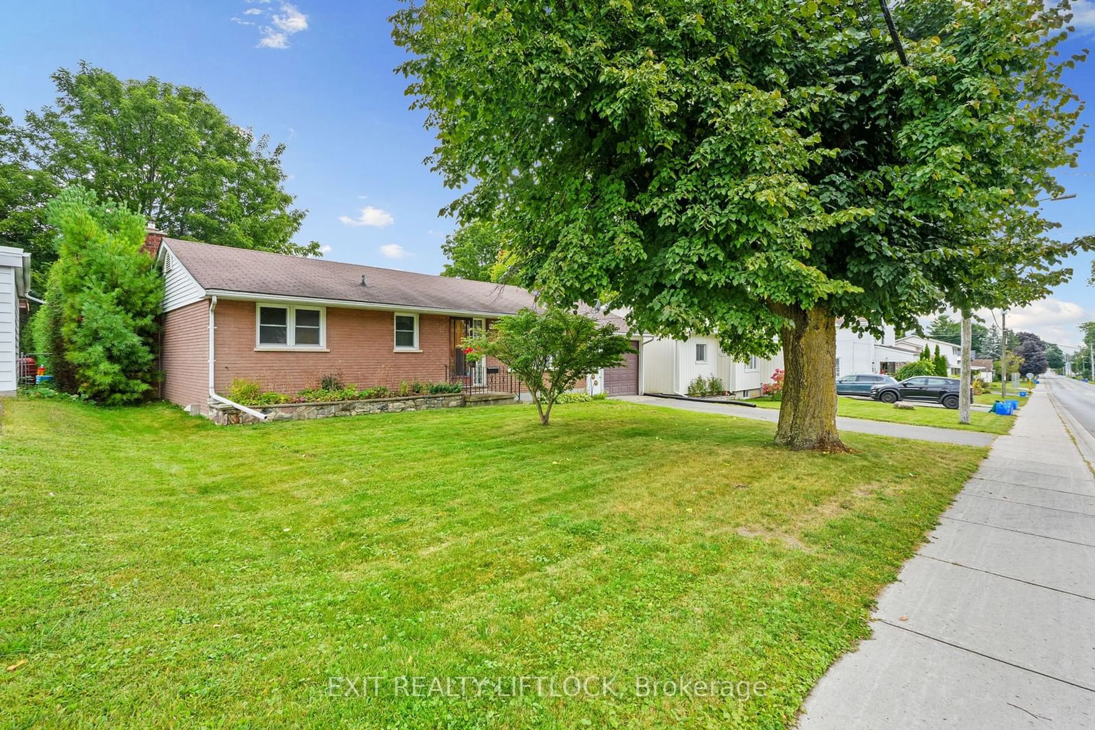 Frontside or backside of a home, the fenced backyard for 83 Alice St, Brighton Ontario K0K 1H0