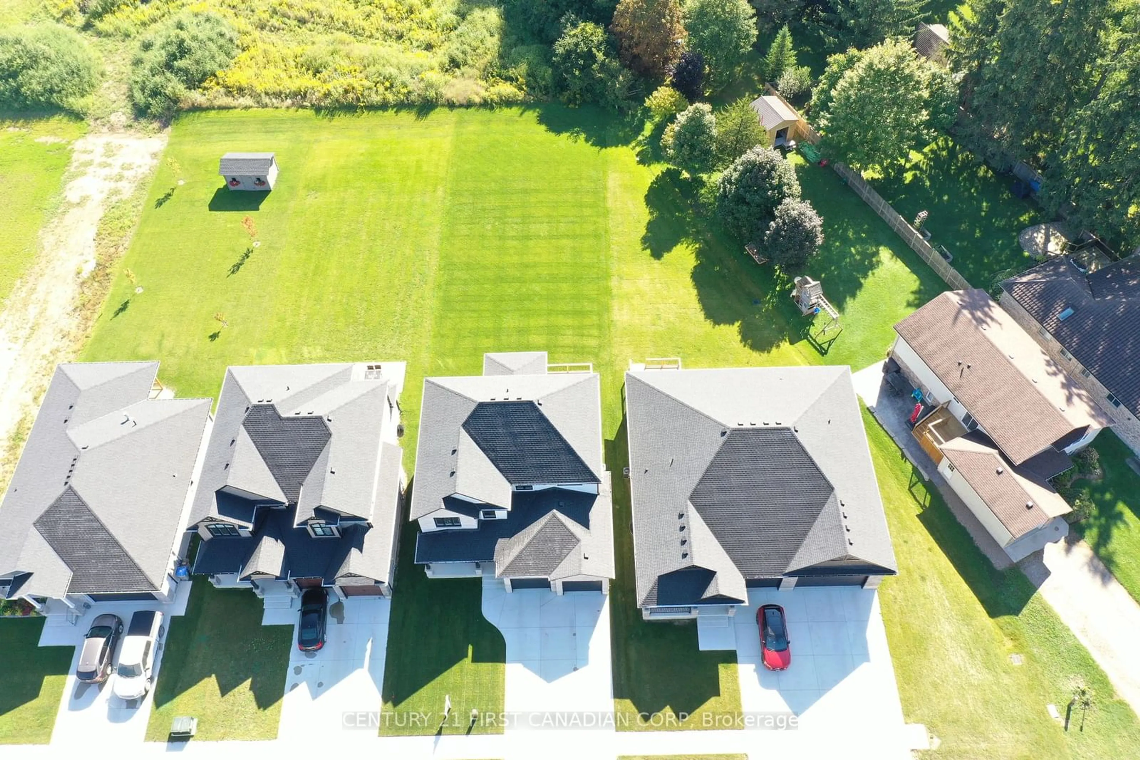 Frontside or backside of a home, the fenced backyard for 90 Queen St, North Middlesex Ontario N0M 1A0