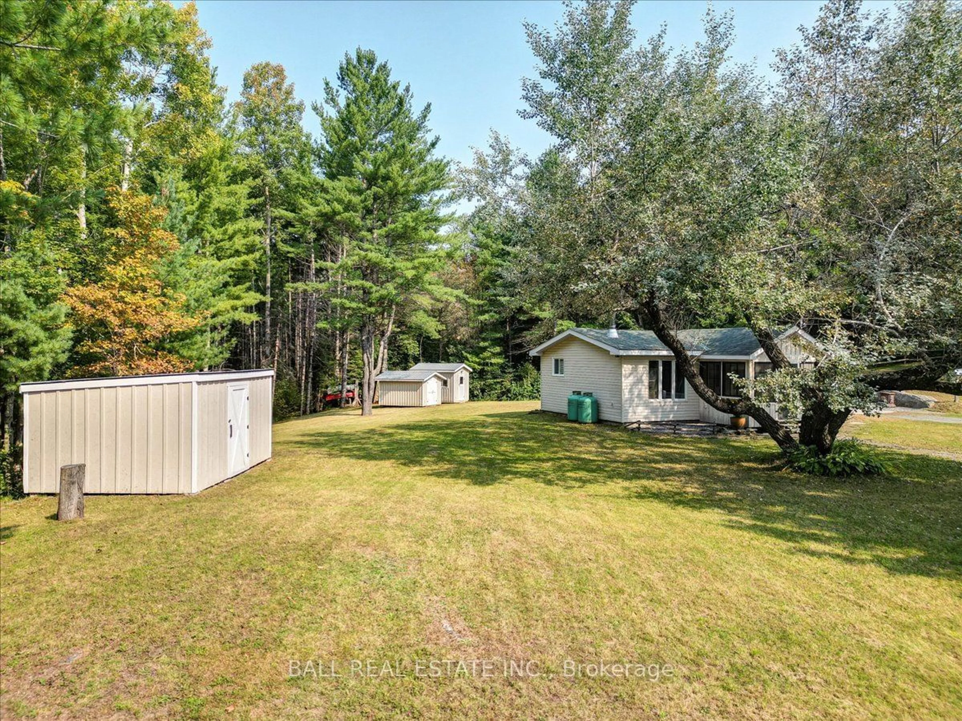 Frontside or backside of a home, the fenced backyard for 26 Balmer Rd, North Kawartha Ontario K0L 1A0