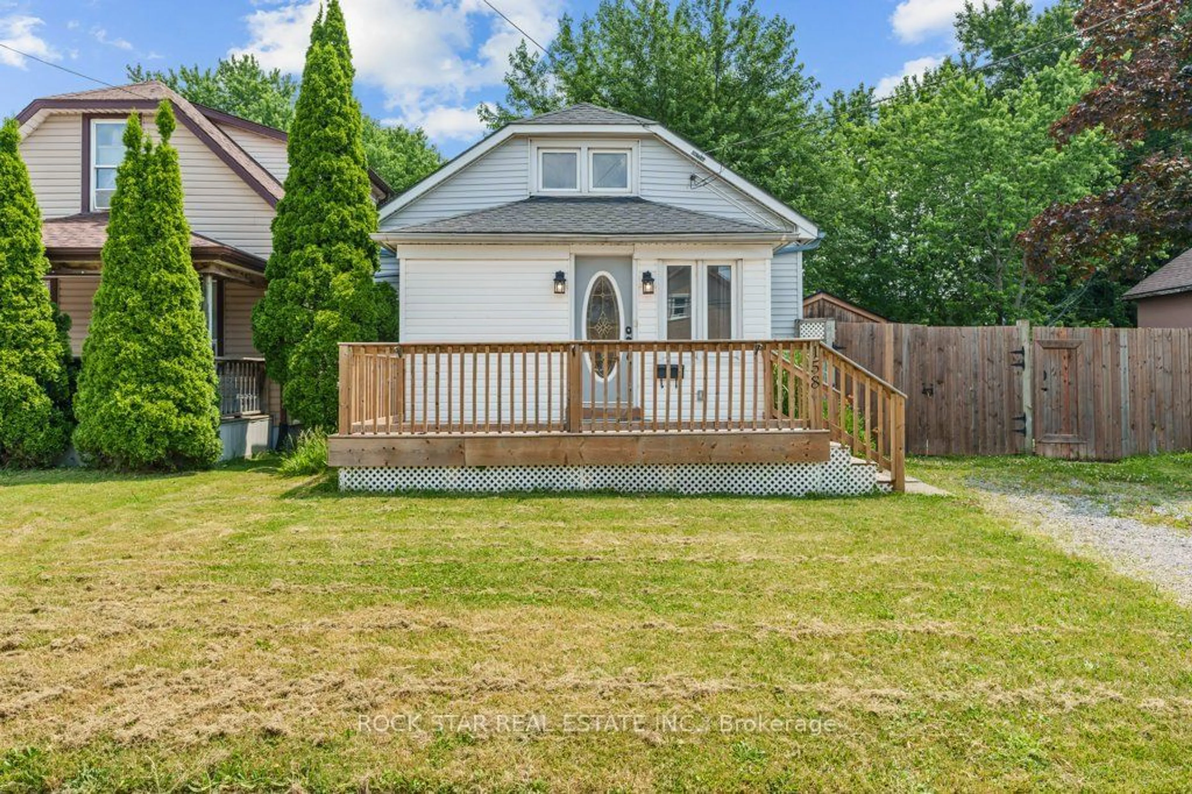 Frontside or backside of a home, the fenced backyard for 158 Crowland Ave, Welland Ontario L3B 1X3