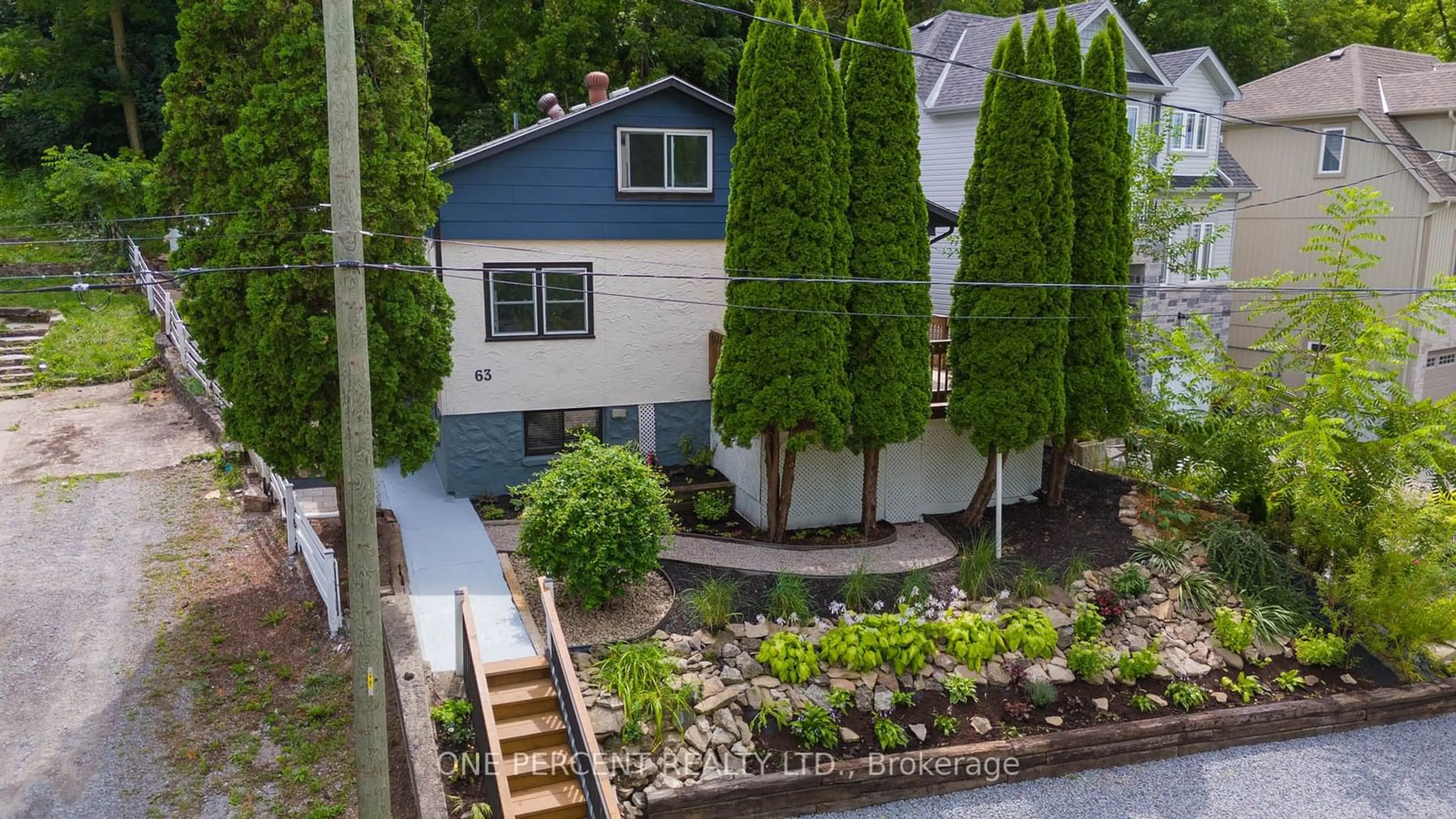 Frontside or backside of a home, the fenced backyard for 63 Bradley St, St. Catharines Ontario L2T 1R5