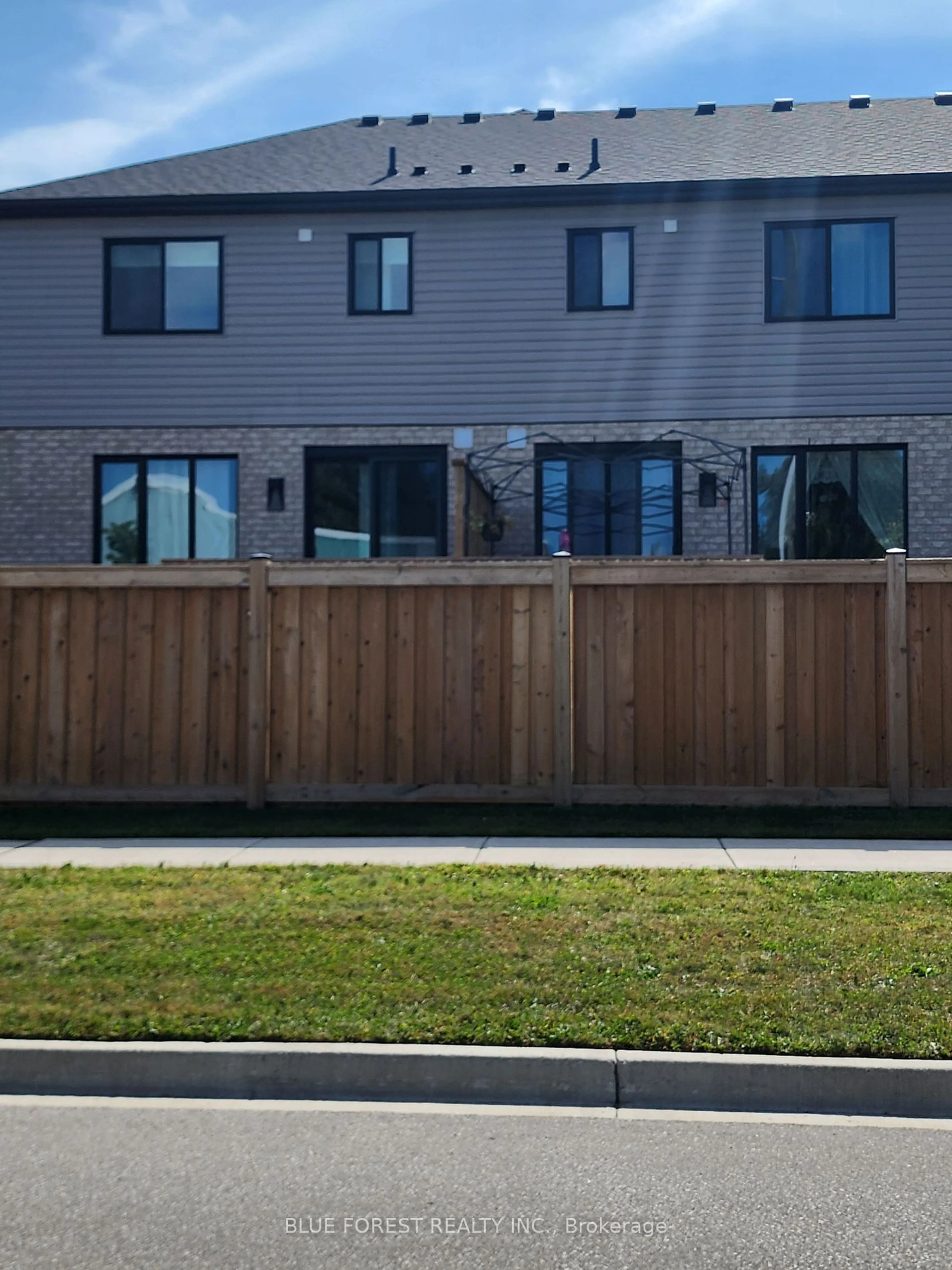 Frontside or backside of a home, the fenced backyard for 601 Lions Park Dr #71, Strathroy-Caradoc Ontario N0L 1W0