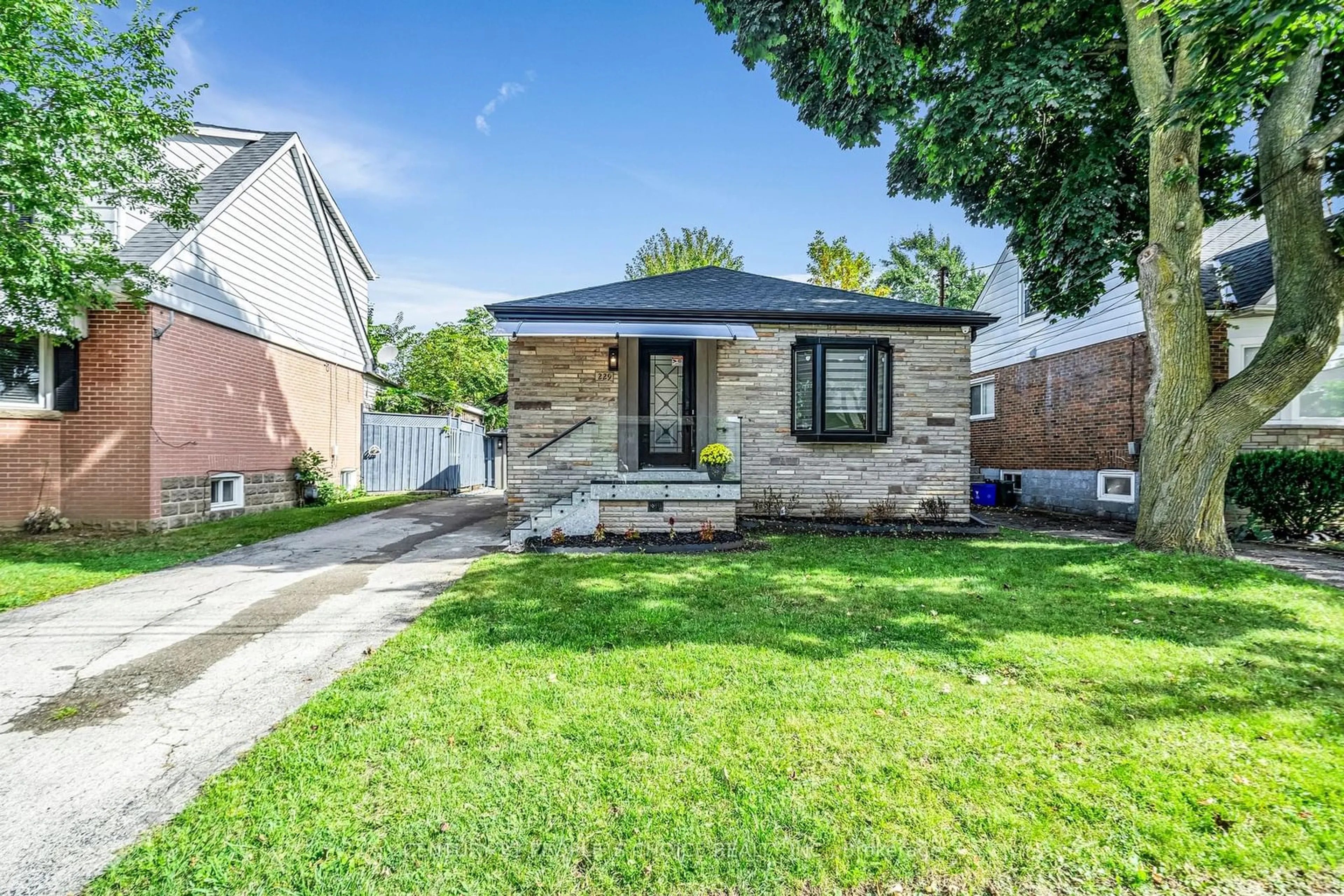 Frontside or backside of a home, the fenced backyard for 229 East 14th St, Hamilton Ontario L9A 4B7